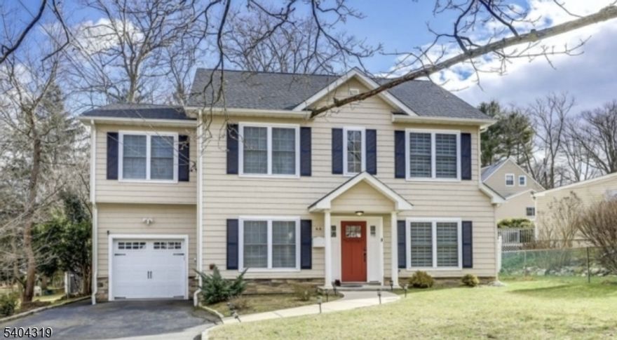 Gleaming hardwood floors flow throughout this beautifully maintained home, highlighted by a gourmet chef's kitchen featuring a center island with granite countertops, custom cabinetry, and generous workspace. A convenient first-floor bedroom and full bath provide ideal flexibility for guests. The stunning primary suite impresses with double-door entry, tray ceiling, and a spacious walk-in closet. The spa-like primary bath features an oversized walk-in shower and refined finishes. The second floor is completed by an additional ensuite bedroom, two more bedrooms, and a full bathroom. Sliding glass doors from the family room open to a paver patio perfect for outdoor entertaining. Ideally located close to schools and houses of worship. EV charger has been installed.