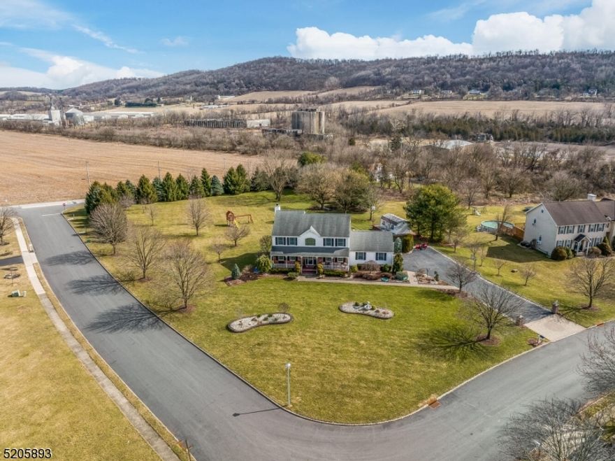 Nestled in desirable Franklin Township, this lovingly maintained 4-bedroom, 2.5-bath Front Hall Colonial on 1.84 acres is ready to welcome you home.A gorgeous covered front porch with charming fretwork sets the tone perfect for rocking chairs and soaking in the peaceful surroundings. Inside, you'll find an open floor plan featuring hardwood floors, specialty moldings, and custom built-ins that add both character and function. Formal living & dining rooms are ideal for hosting gatherings. The beautifully 2025 kitchen showcases stainless steel appliances, quartz countertops a wall of windows &  breakfast bar, seamlessly opening to the inviting family room with a wood-burning fireplace flanked by custom built-ins offering ample storage and display space.Upstairs, the spacious primary suite features 2025 bathroom and large walk-in closet. Three additional light-filled bedrooms share 2025 full bathRm. Finished basement provides even more entertaining space. Step outside to your private backyard oasis with a large deck overlooking amazing views and a 2025 above-ground pool perfect for summer fun. 2025 roof with owned solar panels - 2025 HVAC system. Professional landscaping with lighting. Attached garage with basement access.Public water (plus well water for outdoor irrigation) No HOA fees.Located near major highways, shopping, restaurants, and parks ideal for commuters! Perfect blend of comfort, charm, and modern updates. Pellet Stove "AS IS" Professional Pictures Soon