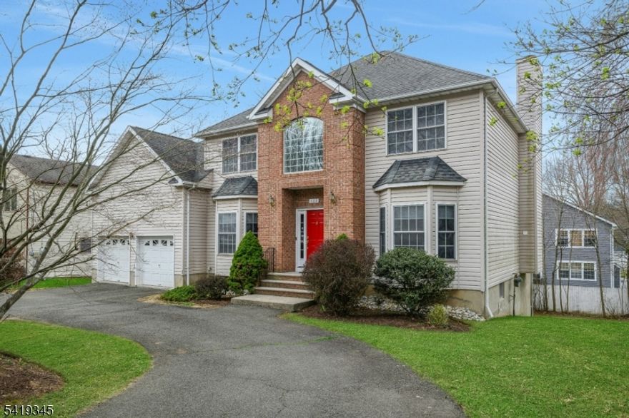 Spacious Colonial filled with natural light, offering a bright and inviting layout perfect for both everyday living and entertaining. A dramatic two-story foyer showcases a stunning high-ceiling chandelier, creating an impressive and welcoming entry. This home features 4 bedrooms, 2 full baths, and 2 half baths, including a well-appointed primary suite. The sun-filled family room, living room, and formal dining room provide generous space and an effortless flow throughout. Well-insulated construction helps maintain a quiet and comfortable interior. The finished walkout basement offers versatile space ideal for a home office, recreation area, or additional living space. A spacious two-car garage provides ample storage and convenience. A circular driveway adds ease of access and enhances curb appeal.Additional updates include a brand-new 75-gallon water heater and kitchen appliances approximately three years old. Ideally located within walking distance to downtown, NYC bus stop, schools, recreation center, and parks. Move-in ready and built with quality craftsmanship by a well-known builder in 1999, this home offers the perfect combination of space, light, and timeless appeal.