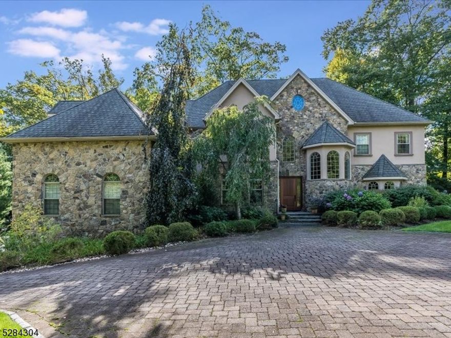 Tranquility abounds in this lovely leafy green 1-acre estate! Your private oasis sits in a serene setting overlooking a stunning gunite saltwater pool & cozy hot tub w/ an impressive stone deck perfect for entertaining. Perched in the coveted Estate Section of Montclair, this 22-year-old home has everything for today's discerning buyer. A delightful foyer welcomes you into a warm, inviting home that leads to a spacious family room w/ wood-burning fireplace overlooking a private deck. The first-floor has a private office, a charming sitting room, & a formal dining room with a separate butler's pantry. The heart of the home is the spacious chef's kitchen, with high-end appliances, the perfect space to gather and connect to the outdoors. On the second floor, the gracious primary suite has large windows, 2 walk-in closets, wet bar, & updated spa-like bath. 3 more spacious bedrooms all with hardwood floors & en suite baths round out the 2nd fl. This home has a working elevator that serves the basement to the third floor & the third floor has roughly 1000Sf of unfinished space w/ high ceilings awaiting your personal touch. Plenty of room for multi-generational living. A full walk-out basement is currently used as a rec room, gym, extra bedroom with a full bath, and media space w/ fireplace. Sophisticated Control4 Home system thru-out..The functionality of this young home in this unique and private park-like setting is one of a kind in vibrant Montclair, only 15 mi west of NYC.,