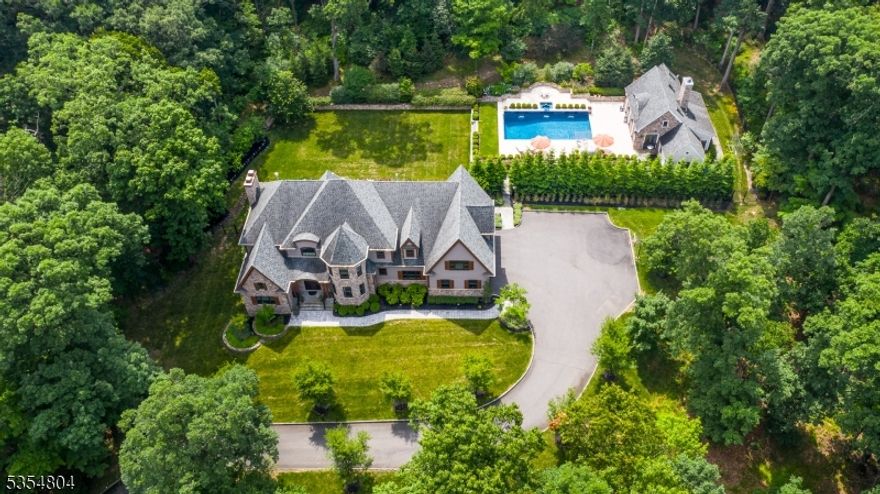 This elegant French country estate, nestled in the scenic Watchung Mountains, presents an exceptional opportunity to establish lasting roots in a welcoming community. Boasting 6 bedrooms and 4.5 baths, this home seamlessly blends sophisticated design with a warm and inviting atmosphere.  A separate guest house - featuring an additional bedroom, catering kitchen and 2 baths - overlooks a sparkling 20'x40' saltwater pool and spa, creating the perfect space for visiting family and friends and summertime entertainment.Meandering bluestone and gravel walkways invite exploration of the expansive 3.06-acre property, leading to beautiful travertine and bluestone patios that become natural extensions of your living space for outdoor gatherings. The expertly designed landscaping provides a breathtaking seasonal display, with flowering trees, bushes, and a vibrant perennial garden creating a picturesque backdrop from spring to fall.This private oasis offers a rare combination of elegance, comfort, and natural beauty an exquisite home where memories are waiting to be made. Interior photos will be available in June.