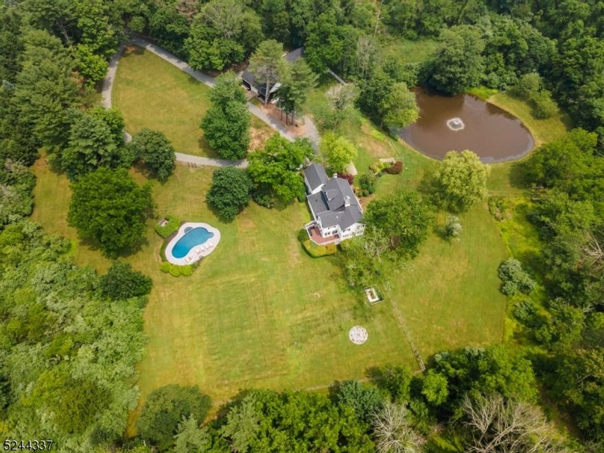 This gorgeous country estate is set on 11 private acres. Coming through the entrance gate you'll feel an immediate calm passing the landscaped pond and manicured pool as you approach the house. Built in 1820 and renovated in 2023, the residence balances a stucco exterior with modern interior finishes. It features 6 bedrooms and 4.5 bathrooms totaling 3,600 sq ft of interior space on 4 floors. The gourmet kitchen is a chef's dream outfitted with a La Cornue range, Miele coffee maker and dishwasher, and Sub-Zero refrigerator surrounding a large center island. Off the kitchen is a formal dining room decorated with bespoke Gucci wallpaper sourced from Italy, with sliding glass doors to a second-floor terrace with views of the pond and garden. The great room features wrap-around windows with a double staircase that frames a wood-burning fireplace adding to the allure of this historic estate. Major updates have been made including new water filtration, new forced air system operated by Nest thermostats, Ring security cameras, and Sonos sound throughout the house and terraces. The barn includes a 2-car garage, 1 bedroom/gym with full bath perfect for in-law or guest suite with ample storage. Located just 3 miles from the center of Chester and surrounding towns. You're minutes away from great shopping and dining, world class golf and equestrian facilities, and award-winning private and public schools. This is a one-of-a-kind property ideal for a primary residence or vacation home.