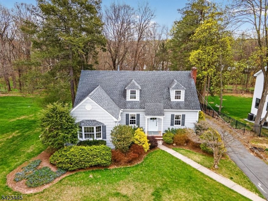 Charming 1942 custom Cape Cod offering approximately 2,614 sq. ft. (original 1,500 sq. ft. plus 1980s addition), set on a beautiful, open, fairly level lot w/ a detached 2 car garage & a serene wooded backdrop featuring a peaceful brook. 3BR, 3 full BA home is rich in character & offers an excellent opportunity for renovation & restoration.The foyer opens to flexible living spaces. To the right, a room currently used as a dining area features custom built-ins & a wood-burning fireplace. To the left, a second versatile space also w/ built-ins can serve as a formal living room or sitting room. Hand-crafted moldings & original hardwood floors add warmth and detail throughout much of the home.The original Cape section showcases curved archways leading upstairs to two bedrooms w/ original hardwood floors & a full bath with tile finishes and tub insert. The left-side bedroom includes access to a walk-in attic, providing additional storage. The first-floor primary BR is bright & generously sized, w/ carpeting & an en-suite full bath w/ tub insert. The EIK offers a generous footprint & is ready for renovation. Off the kitchen, an enclosed sun porch sits on one side, while a spacious great room on the other features a second wood-burning fireplace, skylight, natural light, & sliding doors to the rear deck. A third full bath w/ stall shower completes the main level. Additional features include radiator heat, baseboard hot water heat, CAC, public water, and public sewer.