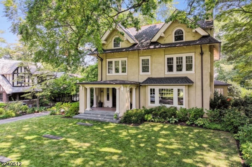 This beautifully restored home is fully updated for modern living and is filled with original architectural details including high ceilings, stained glass windows, oversized fireplace, wood paneled living room and dining room, and gleaming hardwood floors throughout. Meticulously maintained, this home features 4 levels of living; including a new top-of-the line kitchen with double doors that open onto a beautiful blue stone multi-level patio overlooking the expansive backyard which features extensive mature plantings, and a three car two story carriage house. The 2nd floor has a sumptuous primary suite with fireplace, marble bath, and a large custom dressing room. Two additional bedrooms and a bath complete this floor. Four bedrooms & an updated bath on the 3rd floor. Fully finished lower level with recreation room, billiards room, powder room and laundry add to this amazing home. Close to NYC direct transportation, this home is fully done and move-in ready.