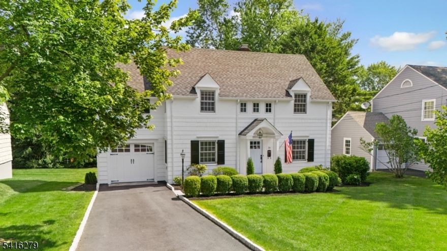 CLASSIC STUNNER IN COVETED CHATHAM NEIGHBORHOOD! Tucked in the Lafayette section, this 1930s Colonial impresses w/ elegant, period details (original hardwood floors, delightful built-ins, rattan light fixtures) updated for modern living. Stately curb appeal w/ classic architecture, meticulous landscaping, and bluestone walkway to Front Portico leading into gracious Entry Foyer. Living Room boasts gas fireplace with brick surround, original woodwork/bookcases, glass door to Covered Deck, and 4 sun-filled windows. Dining Room scaled for large gatherings. Chef's Kitchen updated with Peninsula seating, s/s appliances (inc. Viking stove/hood), and lovely shuttered window overlooking Patio. Graceful staircase w/ window on landing beckons up to 4 generous Bedrooms, all with hardwood floors. Full Hall Bath updated w/ glass-door tub/shower, storage cabinet, marble counters, shuttered window. Primary Bedroom w/ built-in dressers, window seat, large Closet, rattan pendant light. En-Suite Bathroom w/glass-door shower, storage cabinet, marble counters, wainscoting. Brand new (2025) Lower Level renovation includes Laundry Room and lots of bright space to use as Home Office, Exercise Studio, Play Room, etc. Freshly Painted Inside and Out! Level, tree-lined Backyard w/ room for garden and games, Covered Deck w/ ceiling fan, and more! Blocks to NYC train, top-notch schools, and bustling downtown Chatham, 30 Edgewood is poised to please!