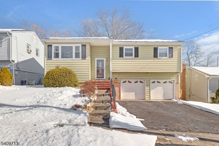 Welcome to this sun-filled, move-in ready 4-bedroom, 2.5-bath bi-level home nestled on a quiet, tree-lined street, offering the perfect blend of space, convenience, and lifestyle.The main level is bright and inviting, featuring a spacious living room flooded with natural light, a formal dining area, and an eat-in kitchen with abundant cabinetry and prep space. In addition to the private primary suite with its own full bath, you'll find two generously sized bedrooms on the main floor, providing flexible living options for guests, or a home office, along with an additional full hall bathroom. The ground level offers exceptional versatility, complete with a comfortable family room, a fourth bedroom, and a beautifully updated half bath with new flooring completed last year. A conveniently located washer and dryer on the ground floor with direct access through the garage makes daily living effortless. Step outside to enjoy a spacious backyard ideal for entertaining, relaxing, gardening, or play. The home also includes an attached two-car garage and excellent storage. Location is a true highlight, close to major highways, NYC transportation, shopping centers, dining, parks, and everyday conveniences, making commuting and lifestyle needs incredibly easy.