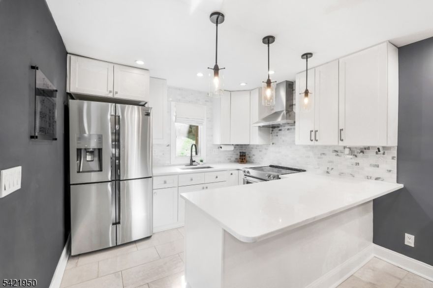 Your posh 1 bedroom + guest room hidden retreat awaits in sought-after Hidden Village, where every day feels like a getaway. Perfectly positioned just minutes from Mountain Creek Ski Resort, waterpark, bike park, Minerals Spa and Golf, the Appalachian Trail Boardwalk, and The Farm at Glenwood Mountain, this location is a dream for outdoor enthusiasts and lifestyle seekers alike. Plus, you're less than 15 minutes from charming Warwick, known for its historic downtown, boutique shops, restaurants, Warwick Valley Winery, Pennings Farm Market & Cidery, and classic drive-in movie theater. Inside, this beautifully renovated condo has been meticulously designed with a stylish, modern aesthetic. The main level features a stunning kitchen with white shaker cabinetry, quartz countertops, high-end stainless steel appliances, and marble flooring. A designer full bath showcases heated black herringbone tile floors, smart fan, and a modern medicine cabinet. The main floor also includes a laundry room and dining space overlooking the dramatic cathedral-ceiling living room below with a wood-burning fireplace. Sliding doors lead to a private balcony with a storage closet. The lower level offers bonus space with closets, ideal for a guest room, recreation area, or home office. Additional highlights include smart technology throughout, newer furnace, and central A/C unit. The complex is currently getting new roofs and siding! More value! Water, sewer, garbage, snow removal included in HOA fee!