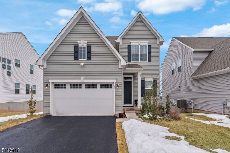 Perryville Ridge, Ryan Homes Ballenger model built in 2023. Bright and airy 3 BRs, 2.5 Baths home on premium lot with stunning views of valley and mountains. Located less than 1 mile from Rt 78, this home benefits from a country setting and easy highway access. Minutes from downtown Clinton and approximately 30 mins to Bridgewater and Flemington.Open floor concept living area, Foyer/Flex room, Kitchen, DR and LR on first floor with woodgrain vinyl flooring throughout. Kitchen features white shaker cabinets, quartz countertops with island seating area and GE Profile Stainless Steel appliances. Upgrades include glass tile herringbone patterned backsplash in kitchen, gas fireplace and sliding doors to covered porch. A half bath completes main level. Second floor consists of Primary bedroom with two walk-in closets, en-suite bath with double sink and extra large shower. 2 additional BRs and flexible open workspace Office/Study each with a large closet, Main bath with tub, laundry room and linen closet complete the neutrally carpeted 2nd floor. Walk-out basement with sliding doors to back yard and upgraded with roughed-in plumbing for future build-out. Home is equipped with WiFi Enabled Smart Thermostat, driveway and backyard facing Ring flood-lights, and on-demand water heater.Community ammenities: Playground, Dog Park and Pickleball Court.Owner/Seller is a NJ Licensed Real Estate Salesperson.