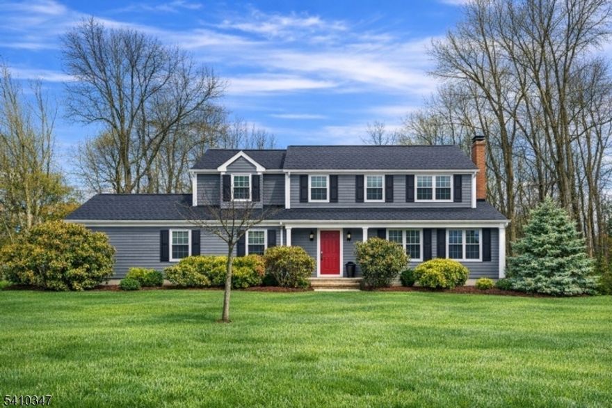 Beautifully maintained 4-bedroom, 2.5-bath Center Hall Colonial set on a generous 0.80-acre property in one of Basking Ridge's most desirable neighborhoods. This inviting home features hardwood floors, newer windows, updated bathrooms, and a warm gas fireplace in the family room, the perfect spot for cozy evenings and holiday gatherings. The sun-filled kitchen opens directly to a spacious deck, creating an effortless indoor-outdoor flow ideal for weekend barbecues, morning coffee, or entertaining friends and family. Upstairs offers four well-sized bedrooms, providing comfortable space for everyone, while the finished lower level is perfect for a recreation room, home gym, playroom, or media space,  whatever suits your lifestyle. The beautifully landscaped backyard is both private and expansive, offering plenty of  room for play, gardening, or simply relaxing in a peaceful setting. Located just minutes from downtown Basking Ridge, NJ Transit, parks, and highly rated schools, this light, bright, and exceptionally cared-for home combines timeless charm with everyday convenience  an ideal place to create lasting memories.