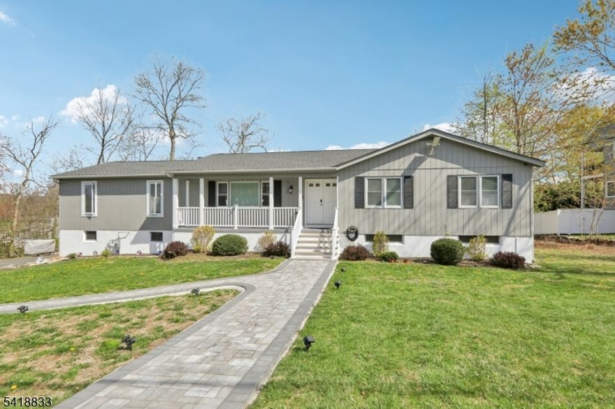 Beautifully updated 4BR, 3BA ranch in the desirable Lake Forest section of Lake Hopatcong. The home features an inviting open front porch, and a flexible layout with multiple living zones, ideal for anyone needing additional space or privacy. or anyone needing extra space.  The first floor offers an updated kitchen, dining room with access to the deck, a spacious living room, laundry connections, an updated hall bath, and a private primary suite with its own updated bathroom and separate sitting room with fireplace. Three additional bedrooms and second full bath complete the main level. The walkout lower level expands the living space with a large rec room, a bonus room with walk-in closet, newly renovated ensuite bathroom, and direct access to an impressive 6-car tandem garage (2-car width). perfect for hobbyists, storage, or workshop needs. Major mechanical upgrades include newly connected natural gas, a new direct-vent hot water heater, new forced hot air heat and central AC, plus a dual-head mini-split system serving the finished basement rooms. A rare combination of updates, space, and garage capacity in a sought-after lake community move-in ready and packed with value. Exterior painting is in progress.