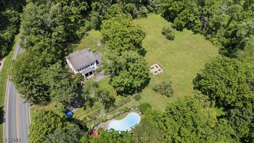 Renovated 1875 Colonial is an exquisite blend of old-world charm & modern luxury. Nestled on 3+ acres of meticulously kept property in Chester, this home boasts vintage details blended with contemporary conveniences & is near Chester town center, shops, dining, top schools, recreation, Route 206 & more. This 4 bedroom, 2.5 bath home offers 3 floors of living space. A rocking-chair front porch welcomes you to a gracious formal dining room with refinished pumpkin pine floors, brick & stone fireplace & exposed beamed ceilings. To the left is a large eat-in kitchen with rich wood cabinetry, quartz countertops & stainless-steel appliances (Bosch & Bertazzoni). The "back  kitchen has more cabinetry, soapstone countertops & adjoining laundry room. Right of the dining room is a bright & airy Great Room complete with wood burning fireplace, beamed vaulted ceiling, hardwood floors & large windows, offering a cozy atmosphere. Completing this level is a hall powder room. The 2nd floor hosts 3 sizable beds, full bath & foyer leading to the 3rd floor private primary suite with vaulted ceilings, hardwood floors, exposed brick, reading nook & luxurious ensuite with oversized shower. A secluded backyard oasis invites you to swim in the salt-water in-ground pool, sit by the firepit, dine on the side patio off the kitchen, play games on the lush lawn, or tend your perennial garden & mature apple trees. This gem also boasts a generator hookup, newer septic, furnace & well.