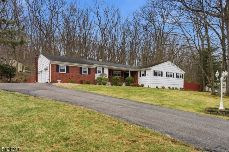 Sprawling 4 bedroom ranch set on a beautiful 1+ acre corner lot in one of Denvilles most desirable, quiet neighborhoods. This well loved home, owned by the same family since 1983, offers an incredible opportunity to create your dream home with a great layout, solid bones, and endless potential. Featuring 2 full baths including a primary suite, a classic foyer entry, spacious living room, formal dining room, and a sun filled kitchen with pantry space. The inviting family room showcases soaring vaulted ceilings with exposed beams and a brick-faced wood-burning fireplace, with sliders leading to a large rear deck overlooking a private, wooded setting, perfect for relaxing or entertaining. Additional highlights include a 2 car garage, dedicated laundry room, electric car charger outlet, and a full unfinished basement offering tremendous potential for future living space. An in ground pool exists on the property (not used in many years) and is being sold as is. Public utilities, central air conditioning and baseboard heating add to the homes practicality. Located in the heart of Denville, known as the Hub of Morris County, enjoy top rated schools, a vibrant downtown filled with shops, restaurants, and community events, plus easy access to NJ Transit, major highways, and NYC commuting options. A rare chance to customize a home in a premier location with space, privacy, and long-term value.