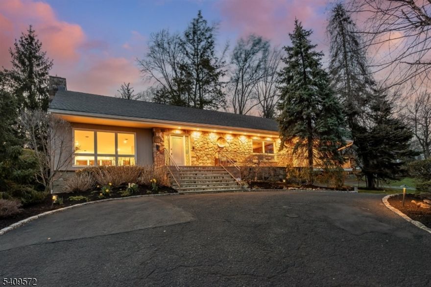 Sprawling and beautifully designed home with an open floor plan ideal for both everyday living and entertaining. The large entry hall welcomes you into a dramatic sunken living room featuring a floor-to-ceiling fireplace and seamless flow,  to the dining and kitchen spaces, and powder room. The chef's kitchen with 5 burner Bosch gas cooktop, Bosch DW, double wall oven, butcher block counter area offers an inviting layout with a large island, perfect for gathering, cooking, and casual dining. A generous first-floor primary suite provides a private retreat with two walk-in closets and a spacious bath. The immense second level offers a primary-sized bedroom plus three additional bedrooms, two full baths, and a large attic/storage area. The finished basement expands the living space with two large recreation spaces, powder room, built-in bar, ceramic tile flooring, and direct access to the oversized attached garage, creating a convenient mudroom entry.  The versatile and stylish back patio and deck space feels like a home in the Hollywood hills! A 1/2 mile to South Orange Village and all its offerings, as well as the train to NYC. This special home awaits your arrival.