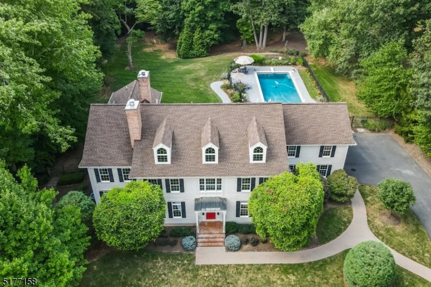 This magnificent 5 bedroom, 5 1/2 bath colonial with a gorgeous pool and 3 car garage is located on a prestigious street in the sought after Convent Station section of Morris Twp. Set back beautifully on 2 acres, this is a special home waiting to bring you a lifetime of memories. With two different possible in-law suites and generous room sizes throughout, the exceptionally flexible floorplan is sure to please a vast array of buyer needs. The first and second levels offer over 5,200 sf while the full finished walkout basement boasts an additional 2,500+ sf. The large kitchen has a center island with bar seating, a large eat-in area, separate wet bar, and walk-in pantry.  Upstairs you will find four bedrooms, three full baths, the primary suite's sitting room (or nursery, or office), laundry room, and large bonus room, in addition to multiple storage rooms. The vast multi room basement boasts a large rec room (TV area plus ping pong table), a game room, and a full bath. Have your pick of offices with multiple candidates on each level.  If you've dreamt of hosting large events, look no more. It is possible to own a large estate close to the train station (3/4 mile) and the beautiful downtowns of Morristown and Madison. The savvy buyer will enjoy the superior craftsmanship and steel beam construction (building class 20) of this meticulously maintained home. IMPORTANT: Please request the features and upgrades sheet to fully appreciate all that this special home has to offer.