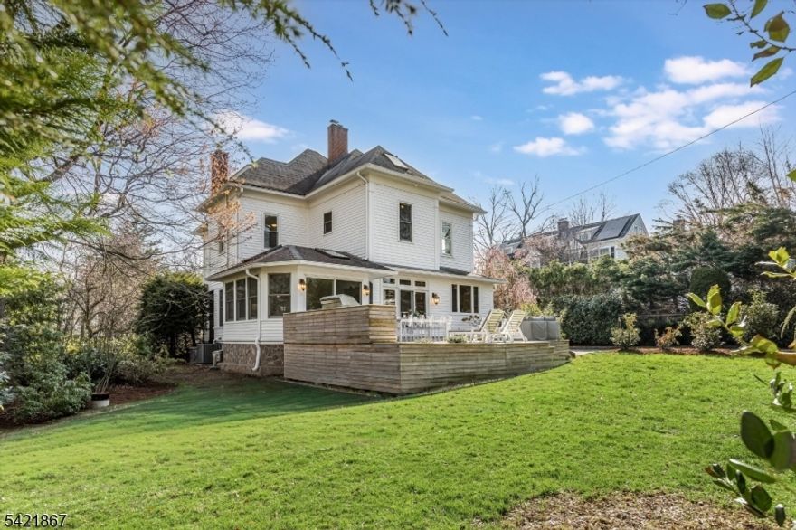 Welcome to this quintessential, stately Montclair residence where timeless elegance meets modern comfort set on one of the town's most sought-after streets. Enter through the orig. front drs to soaring ceilings, abundant natural light, & exquisite period dtls including oversized pocket doors & intricate moldings, creating a warm, inviting atmosphere.The main lvl offers a versatile layout w/ a gracious frml LR, space for a prvt office, & an expansive dng rm perfect for hosting gatherings & holiday meals. At the heart of the home is a chef's kitchen feat. an oversized island, wet bar w/ wine fridge, & loads of cabinetry.Just beyond, the spacious FR impresses w/ cathedral ceilings & skylights that flood the space w/ light. This seamless kitchen/FR combo is ideal for everyday living & entertaining, complete w/ radiant heated flrs & direct access to the beautifully landscaped backyard & deck for effortless indoor-outdoor flow.Upstairs, the prim suite offers a priv bath & WIC. The 2nd flr includes 3 add'l bdrms & full bath, w/ 1 currently used as a sitting rm. The 3rd flr adds 2 lrg bdrms & full bath perfect for guests or flex living space. A breathtaking wraparound frnt porch, lush landscaping, & a newly built modern rear deck with built in TEC grill complete this exceptional home just a stones throw from town, dining, shops & NYC direct train. This is Montclair living at its finest: elegant, spacious, and effortlessly welcoming.