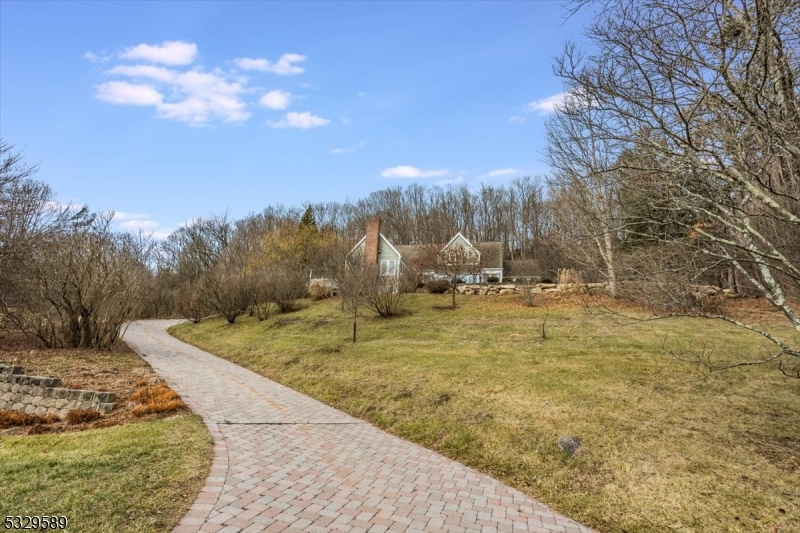 This custom Acorn home, spanning approximately 5000+ sq. ft., was built onsite by Thomas Schroll. The home's architecture, soaring ceilings on both levels, and thoughtfully designed floor plan create a timeless connection with nature, offering an expansive living experience. The Great Room features a peaked cathedral ceiling and dramatic windows, allowing for ample natural light & pastoral views. The fireplace blends into the walls, so the emphasis is on the room's vast openness, floating beams & large windows. The first of two primary bedrooms is on the first floor &has a w/in closet, full bath, & private deck. The kitchen has a large center island that opens to both the rec rm with large windows & the breakfast room. The kitchen & baths have custom-made tiles & flooring. The adjacent office has a peaked ceiling, floating beams, & built-in shelves. The custom cabinets in the kitchen, rec rm, office, & laundry are made of solid cherry, to last a lifetime.  The 2nd flr feels like a 1st flr w high ceilings. Don't miss the 3 distinct areas that overlook the living rm, dining rm, and office below. There are 3 more bedrooms & 2 full baths, one of which is in the 2nd primary bedrm. The home has a 3-zone heating system, 3 furnaces, with an electric air cleaner. It also has 3-zone central air, with 3 separate units, a propane whole-house generator that powers the entire home, & owned solar panels. Many windows have been replaced, along with some bathroom fixtures. New Septic 12/7/24