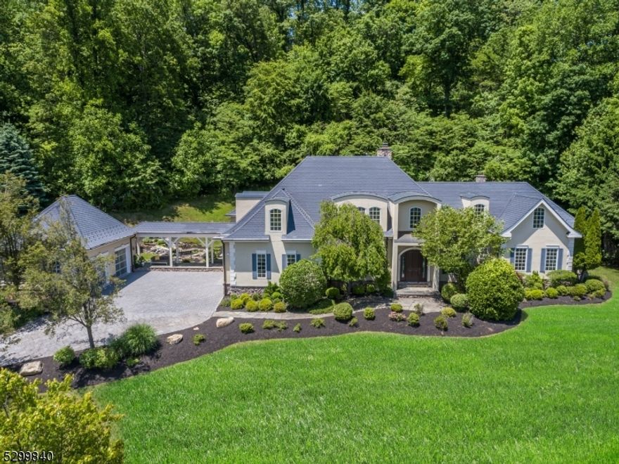 Custom built majestic home on 2.23 acres, 6,896 square feet, beautifully appointed w/ high-end finishes & stunning architectural details. 6 bed, 5 full & 2 half baths, sprawling, private & sun-drenched featuring exquisite craftsmanship, expansive interior & lush, resort-like grounds w/ heated saltwater pool & coveted skyline views. A myriad of thoughtful details include, open layout, designer finishes, plentiful windows & dramatic spiral staircase. The jewel-box of a dining room is perfect for hosting any affair. Designer kitchen features white cabinets, granite countertops, center island & breakfast bar, dual sinks, Hans Grohe faucet, Wolf double oven & 6-burner gas Wolf cooktop & warming drawer, Sub Zero fridge & Sub Zero freezer and Wine refrigerator. Also on the first floor is the primary bedroom, w/ 2 expansive walk-in closets, dressing areas & custom built-ins, a spa-like full bath w/ dual sinks, separate jetted tub and radiant heated stall shower, complete the primary suite. Dual powder rooms, family room, one of the two laundry areas and more complete the first floor. Upstairs, five graciously appointed bedrooms & baths allow guests to unwind in luxurious surroundings. Outside is a convenient heated driveway and walkway. Dual garages. Attached garage with lift and detached garage with space for 2 additional lifts. This one of a kind home rivals any resort. Close proximity to shopping, recreation and transportation to NYC