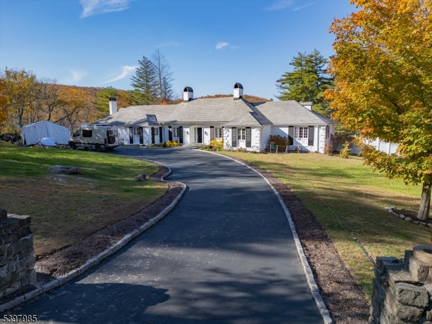 Welcome to 18 Pepperidge Tree Terrace in Smoke Rise, Kinnelon.Elegant Country French Ranch on a cul-de-sac with a  5.48 Acre lot. This sun-filled home offers 4 spacious bedrooms and 2.5 renovated bathrooms, including a stunning primary suite with trayed ceiling, honed marble dual-sink vanity, Toto bidet, and heated towel rack.The newly designed eat-in kitchen features modern cabinetry, marble island, granite counters, premium appliances, and two dishwashers. Open floor plan flows into the family room ideal for entertaining.Outdoor highlights include a saltwater pool, smokeless fire pit area, and a charming "Potter's Hut  currently used as a home office. Beautifully landscaped yard with mature trees and gardens.Added features: backup generator, Wi-Fi thermostats, HVAC UV lights, dual-zone heating/cooling, wood-burning stove, and pre-wired home theater. Close to top-rated schools and NYC bus access.A rare Smoke Rise opportunity!