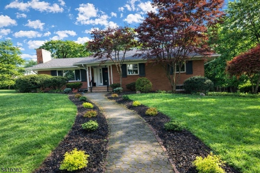 Sophisticated mid-century ranch set on nearly 1/2 acre in the desirable Montrose section of South Orange just blocks from vibrant village shops, restaurants and NYC trains. Extensively remodeled with a modern aesthetic, the flowing floorplan offers bespoke finishes and abundant natural light. A chef's kitchen with views of the expansive yard, features a designer Miele cooktop, steam-assist wall oven & warming drawer by KitchenAid, Caesarstone quartz counters and marble tile backsplash. The 1st floor features new & refinished white oak hardwood floors, double glazed windows and updated lighting, door hardware and switches throughout. The primary bedroom offers ample closet storage and an en-suite bath with spacious shower with glass doors. The ground level was refinished in 2019 with a new bathroom with shower, new laundry room with LG steam washer/dryer and versatile recreation spaces to enjoy as you wish with family room, exercise and guest room/office space. Outside the paver and concrete patio overlooks a spacious, private yard. The exterior has been refreshed with new exterior lighting, concrete stoop (rear), a new driveway with Belgian block curbing (2017) and freshly painted trims. New high-efficiency HVAC (2018), Ecobee thermostat, newer garage door openers, and newer shelving/rods in all closets are a few additional updates you will note. Set amongst elegant period homes on a quiet street, you will enjoy the best of South Orange in this stunning, move in ready home.