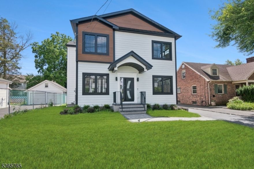 Welcome to a masterpiece of modern luxury in the heart of Millburn! offering 4-bedrooms + Office & 4 full bathrooms, this custom-designed single family home blends sophistication w functionality. Step inside to discover an open floor plan seamlessly connecting the kitchen, dining & living areas - ideal for both entertaining & everyday living. The gourmet kitchen is a chef's dream, featuring an expansive center island w waterfall quartz counters, island prep-sink, top-of-the-line SS appliances & stunning quartz slab backsplash. The living room is centered around a gas fireplace w built-in shelving, chandelier lighting & direct access to a spacious rear deck - perfect for outdoor gatherings. The dining room boasts a custom boxed trim ceiling, elevating the space w architectural charm. While the 1st floor bedroom & full bathroom provides added flexibility. Upstairs, the primary suite is a serene retreat w tray ceiling, designer chandelier lighting, spacious WIC & spa-like ensuite bathroom w double vanity & expansive walk-in shower w floor-to-ceiling tile & elegant gold finishes. The oversized guest bedrooms provide style & ample space for all. The fully finished basement expands the living space, offering a rec room, flexible office/bedroom & full bathroom. This 2025 custom built home is located in a prime location less than 1-mile from Millburn's AWARD WINNING schools & downtown train/shopping/restaurants with easy access to NYC. PERFECT COMMUTER HOME!