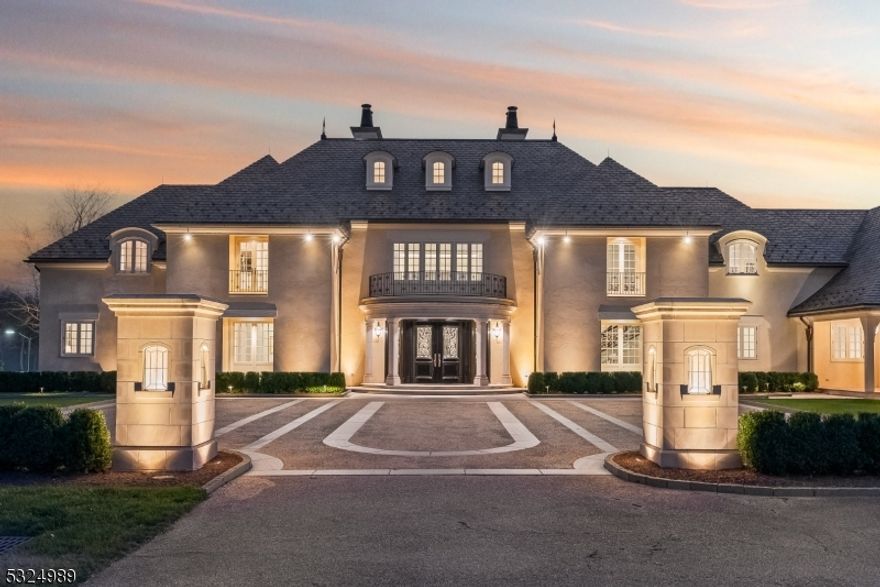 Discover the pinnacle of luxury living in this exquisite 6-bedroom French country estate, set on 11 unparalleled acres. Designed by Brandes Maselli and completed in '08, this architectural masterpiece underwent contemporary updates in 2023. Through a gated entry and winding drive, you will be greeted by the residence's stately stucco and slate facade. Step inside to a world of refined luxury, where custom architectural millwork, rich hardwood floors and limestone fireplaces elevate every space. The gourmet kitchen is a culinary masterpiece, perfectly situated to flow into light-filled living and dining spaces with custom mahogany French windows and doors. The 2nd level features a large in-law suite with private entrance. A fully finished lower level invites recreation and relaxation. The property's outdoor amenities rival those of a luxury resort with an expansive limestone patio, infinity-edge pool,  spa, and notable pool house. A lighted sports court provides tennis and basketball, while a perimeter walking path winds through the landscape. The cottage features a kitchen/living room, bathroom and garage. The rear yard is designed for large-scale tented gatherings/events. Your peace of mind is secured by an automatic generator, irrigation, security system and zoned sound system. This extraordinary estate allows privacy while enjoying proximity to award-winning schools, equestrian facilities, world-class golf courses, upscale shopping and dining, highways and NJ Transit.