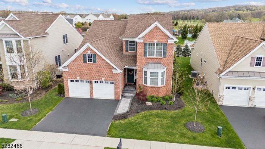 Gorgeous Home, Prime Location, Incredible Amenities! Enjoy luxury living in the prestigious Regency at Flanders, a Toll Brothers 55+ community offering residents a club house, pool, fitness center, sport courts and more. Great location near shopping, restaurants, parks, and golf. Premium lot overlooks the pond and fountain with peaceful vistas. Hammond Federal model home with 3,400+ sq ft, with rich wood floors, high ceilings, custom millwork and impeccable finishes. Sprawling main level with welcoming foyer that flows into a sun-filled formal living room and spacious dining room. Beautiful kitchen equipped with crisp white cabinets, granite counters, breakfast bar, high-end SS appliances, and breakfast area with sliding doors to an oversized paver patio with built-in Weber gas BBQ. Stunning family room with 19' ceilings and electric fireplace with custom-built cedar chimney and side cabinets with wine fridge for effortless entertaining.Main-floor primary bedroom with tray ceiling, walk-in closet and en-suite bath with dual vanities and shower and 2 WIC. An office, 2-car garage, full bathroom, and laundry room complete the first floor. Second floor has a huge loft, 2 more bedrooms, full hall bath with tub and tons of storage space. The lower level boasts 9' ceilings and a lovely rec-room with fireplace and wet bar, plus more storage. Pristine condition, multi-zone heat and central air, whole-house generator, in-ground sprinklers and more--just waiting for you to unpack.