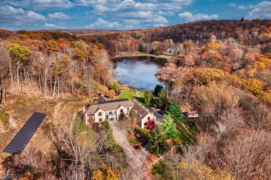 Set on nearly 15 acres of total privacy, this approximate 9,600 sq ft estate redefines lakefront luxury. With three finished levels, six bedrooms, and seven baths, the home offers an extraordinary blend of scale, craftsmanship, and tranquility surrounded by nature. A grand two-story foyer with a double bridal staircase sets the tone for the home?s impressive scale. Beyond the foyer, the massive two-story great room showcases walls of windows framing stunning lake and property views, flooding the space with natural light. The gourmet eat-in kitchen is designed for both beauty and function, showcasing stainless steel appliances and a large center island. A spacious formal dining room offers the perfect setting for hosting. The family room connects seamlessly to the billiards room?an ideal layout for entertaining. This level also includes an office and a powder room. Occupying the full left wing of the home, the primary suite is a private retreat that stretches from front to back. It offers multiple walk-in closets and a spa-inspired bathroom complete with dual vanities, a soaking tub, and a large walk-in shower. The upper level also includes a gym, two additional en suite bedrooms, a Jack-and-Jill bedroom suite, and a laundry room. The fully finished lower level features a custom kitchen and bar area, a theatre room, an additional bedroom, full bathroom, and ample storage. Enjoy a custom pool, cabana, and a private beach along the lake?creating the ultimate escape at home.