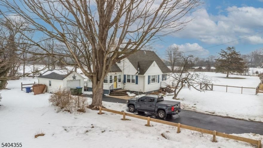 Out in the country, you'll find this charming 50's Cape Cod updated to fit today's modern lifestyle. Step inside to find Open Concept Living-in the Kitchen,Dining &Living Rooms. Picture windows create a bright, warm space. The Kitchen has lots of cabinets, updated counters & a new SS stove(to be installed). Enjoy the view from the Garden window. The Sunroom off the Kitchen is a versatile living space with many possibilities-Office, Play Room, Studio, Mud Room.The Bathroom has been nicely updated. Enjoy HW floors that extend into 2 Bedrooms on the 1st floor. Head Upstairs to find a spacious, uniquely designed Primary Suite. There's s a large Sitting/Dressing Area on your Left. To your right, find the Modern EnSuite. Step inside a charming Bathroom where a soaker tub will bring peace & calm.Continue to a roomy area that includes builtin drawers, sky lights & ceiling fan. The finished basement includes a large Rec Room & Office.  Living continues outdoors. Step out onto the spacious, maintenance free deck or the  large paver patio- entertaining is a breeze. Spend quiet nights listening to the sounds of Nature surrounded by wide open spaces. The bonus is the Outdoor Shower next to the Deck.A spacious Side Yard provides lots of room to roam. Much of the property is fenced in. Two outdoor structures provide plenty room for tools & storage-a One car Garage PLUS a large storage shed at the back of the property. Minutes to town.This one won't last.