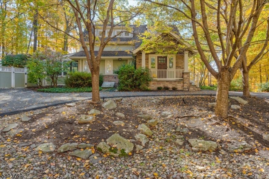 Set in the peaceful countryside of Mendham Twp, this post-and-beam Mid-Century Modern Craftsman offers a rare blend of privacy, character and commuter convenience. Located just minutes from major highways and Midtown Direct train service in nearby Morristown, the home provides easy access to NYC while preserving the serenity of a wooded setting. Sited on over an acre and bordering protected woodlands, the property enjoys exceptional privacy. A circular driveway leads to a covered front porch and tiled foyer w/2 spacious closets. Classic architectural details are complemented by thoughtful modern updates throughout. The renovated kitchen features heated tile flooring, center island, large walk-in pantry, and opens to a sun-filled solarium w/tranquil wooded views. The living room offers a beamed cathedral ceiling and Woodbury wood-burning fireplace. The adjacent dining area provides ample entertaining space w/deck access and backyard views. A 1st floor bedroom offers flexible use as a guest room or home office. Upstairs are 3 additional bedrooms and 2 full baths. The finished basement adds versatile living space, wine cellar and generous storage. Professionally landscaped grounds include underground irrigation, accent lighting, deer fencing, and hardscaping. Notable upgrades; newer furnace, Nest thermostats, EV charging station, 1st floor laundry, whole-house generator. Enjoy Mendham's highly regarded schools, parks, trails along w/nearby Morristown dining, shopping and Trains.