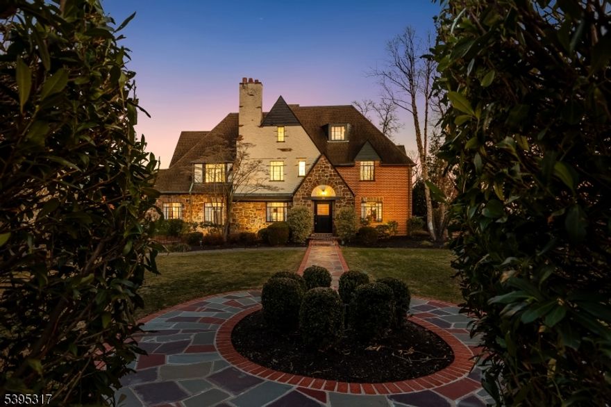 This graciously restored English Tudor sits atop beautiful Crest Drive, offering breathtaking NYC skyline views and a seamless blend of historic detail and modern luxury. Enter the reimagined entryway showcasing Japanese Shou Sugi Ban-inspired wood paneled closets, setting a stunning architectural tone. Inside, curved archways and expansive sunlit rooms provide both warmth and grandeur. The first floor features new herringbone white oak flooring with radiant heat, creating an inviting and elegant flow throughout.  The main level includes the grand open living + dining room with wood-burning fireplace, a sunken family room with sliders to the patio, and a charming country-style eat-in kitchen with access to the screened porch and powder room. Every original window has been meticulously restored by a team of craftspeople, painstakingly preserving the home's timeless character. Fresh paint, new designer carpeting, handcrafted railings, and exquisite new hardware and doorknobs elevate every detail of this exceptional home. Upstairs are five bedrooms and four full baths, including a spacious primary suite with dressing room or WFH space. The third floor Rec room is the perfect hang. Outside, enjoy the private front yard, and back patio, but be blown away by the spectacular heated in-ground pool surrounded by decking with unbelievable views of NYC. This is a truly rare opportunity to own a restored classic on one of South Orange's most coveted streets.