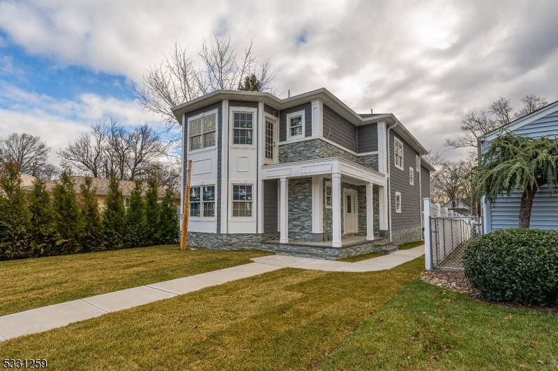 Welcome to this magnificent new construction home, offering modern elegance and thoughtful design on an expansive 40x200 lot. With 5 bedrooms, 4.5 baths, and an array of luxurious features, this home is perfect for those seeking comfort and style. The first floor greets you with an inviting foyer leading to a thoughtfully designed open floor plan. Highlights include a powder room, a spacious living room, and a formal dining room with soaring 9' cathedral ceilings adorned with exquisite crown molding. The state-of-the-art kitchen flows seamlessly into the living spaces, making it ideal for entertaining. This level also features a bedroom with a full bath, perfect for an in-law suite or guest accommodations, as well as a utility room and direct access to the built-in 2-car garage. Upstairs, the second floor boasts 4 additional bedrooms and 3 full baths, including two luxurious master suites with cathedral ceilings. Every detail has been carefully considered, with top-of-the-line materials and finishes throughout. Outside, the property features a long driveway, built-in 2-car garages, and a durable vinyl fence for added privacy. The home is equipped with modern technology, including 6 security cameras with a monitor and DVR system, as well as a front door intercom system with cameras and monitors on both floors for added safety and convenience. With time still available to select your finishes, this home provides a rare opportunity to tailor it to your personal taste.