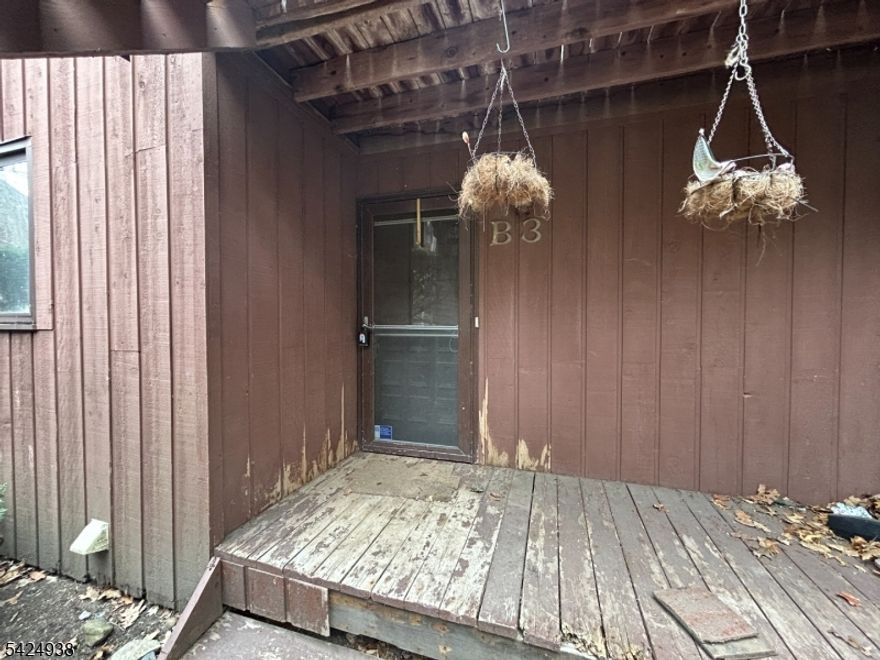 Investor Special! Nestled in the mountains of Vernon, this first-floor, 1-bedroom, 1-bathroom unit offers potential for the savvy flipper or handyman. The open-concept floor plan features a spacious living room with a wood-burning stove and sliding glass doors leading to a private deck perfect for enjoying the mountain air. Includes an eat-in kitchen, large bathroom, and convenient in-unit laundry. Situated in a prime recreational hub, this unit is minutes from Mountain Creek Resort, skiing, waterpark, and mountain biking, Crystal Springs Resort, world-class golf courses, and the Appalachian Trail. Whether you are looking for a profitable fix-and-flip or a long-term rental in a high-demand resort area, don't miss this opportunity. Unit is being sold strictly in "As Is" condition.  Don't miss out on this opportunity!