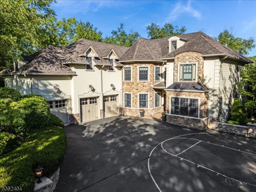 Discover this spacious custom colonial nestled in the sought-after Hartshorn section, offering 5 bedrooms including a first-floor in-law suite and 6 baths. A circular driveway leads to the first floor 3-car garage and a beautifully landscaped backyard with a park-like setting. Enter to a two-story great room featuring a gas fireplace w/custom built-ins. The gourmet chef's kitchen is the heart of the home, complete w/ large center island, high ceilings w/ beam detail, granite countertops, stainless steel appliances, walk-in pantry, butler's pantry and breakfast area that flows into a den with a fireplace. The main level includes a formal dining room with fireplace, elegant living room/office with built-ins, and in-law suite with private bath. Upstairs, the primary suite offers a sitting area, fireplace, spa-like bath, and three custom walk-in closets. Three additional bedrooms all with ensuites and a convenient second floor laundry complete the second level. The walk-out lower level features a massive rec room, new gym floor, wine cellar, guest room/office, full bath, new spa room with sauna, new carpet and new ceiling. Freshly painted interior and newer whole house generator. Enjoy resort-style outdoor living with a newly fully fenced backyard featuring an outdoor kitchen, built-in grill, fireplace, playset, new exterior light fixtures and brand new stairs leading from back and side of the house. Truly an exceptional home that combines luxury, function, and timeless design.