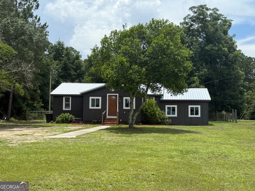 Home is as cute as can be. Everything is new & updated. New metal roof installed last year. All other systems new in 2022. You can own cheaper than renting. Large, vaulted ceiling flex area that could be used as living room, dining or exercise/storage area. Home is an easy commute to Statesboro & Guyton. Country living but close enough for last minute errands. Fenced in back yard with storage building.