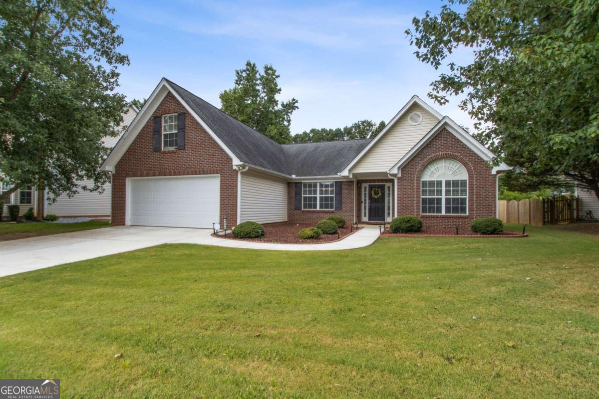 This beautifully updated ranch-style home is located in a desirable swim/tennis community within the highly sought-after North Gwinnett school district. The open split-bedroom floorplan includes a bonus room over the garage, perfect for a home office, guest space, or playroom. The vaulted great room features a cozy fireplace and opens to formal living and dining rooms, both with soaring ceilings that enhance the home's spacious feel. The fully renovated eat-in kitchen is a chef's dream, boasting quartz countertops and backsplash, tile flooring, a stainless steel 6-burner gas range, pot filler, vented hood, and plenty of cabinet space. Throughout the home, luxury vinyl plank flooring offers both durability and style. The spacious primary suite on the main level features a tray ceiling and a completely renovated en-suite bathroom with quartz countertops, a jacuzzi garden tub, separate tiled shower, and a large walk-in closet. A bright and airy sunroom overlooks the fenced backyard, providing the perfect space for relaxing or entertaining. Conveniently located just minutes from I-85, top-rated schools, shopping, dining, and parks, this home blends comfort, style, and location in one exceptional package.