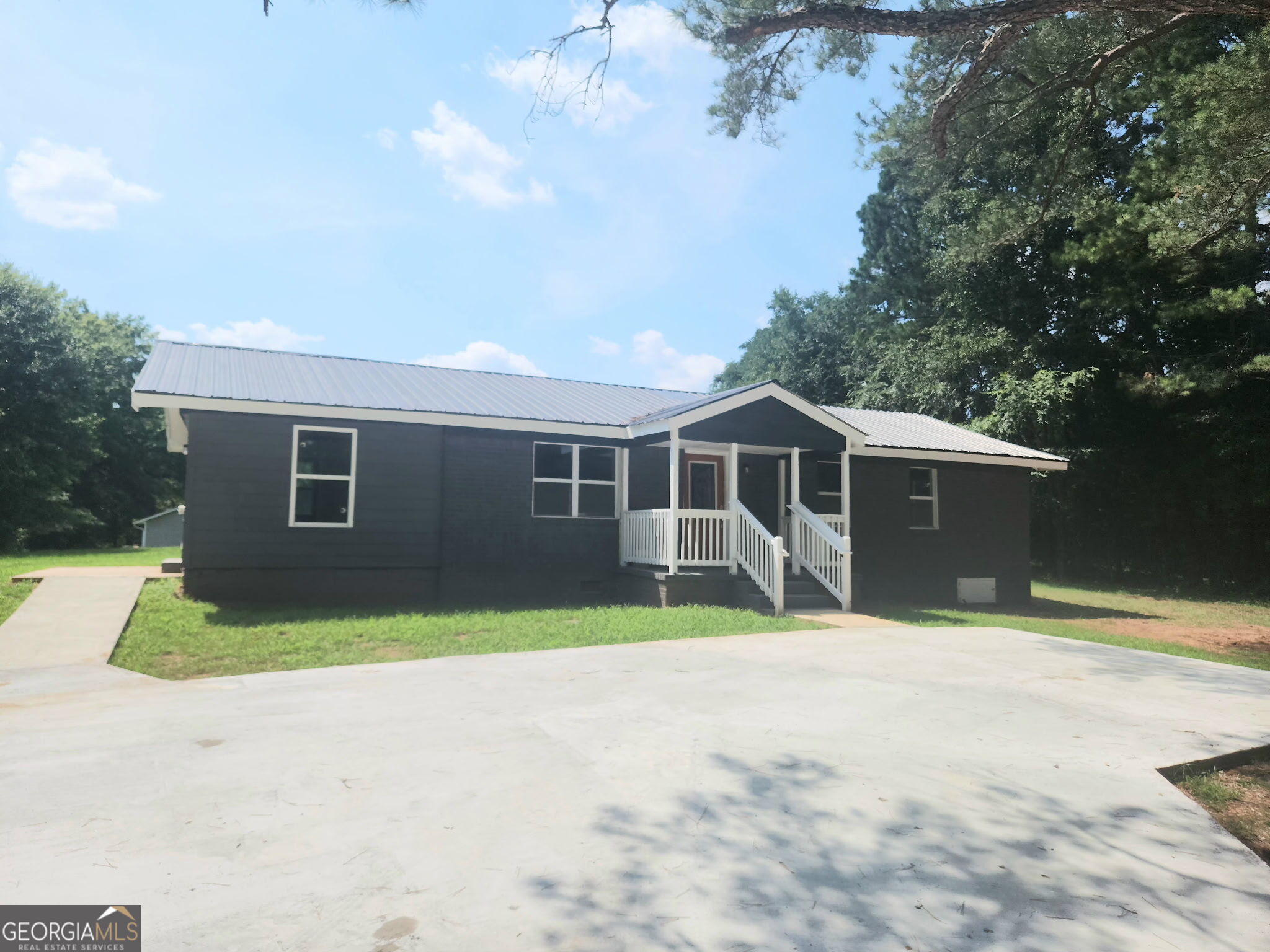 Welcome to this beautiful move-in ready home that blends comfort, convenience, and charm. This 3-bedroom, 2-bath house has been completely renovated with new flooring, windows, HVAC system, water heater, and paint throughout, as well as a new tin roof. This home offers an open concept living area and kitchen to make entertaining simple. With approximately 1,278 square feet of thoughtfully designed living space, making it a great fit for a variety of lifestyles. The well-laid-out floor plan provides a warm flow from room to room, with natural light brightening each space throughout the day. The primary bedroom is generously sized, featuring an en-suite bathroom. This home is situated on a sizable lot, offering plenty of outdoor space for gardening, entertaining, or both. Located just minutes away from charming downtown Greensboro and I-20. Come see this one today!