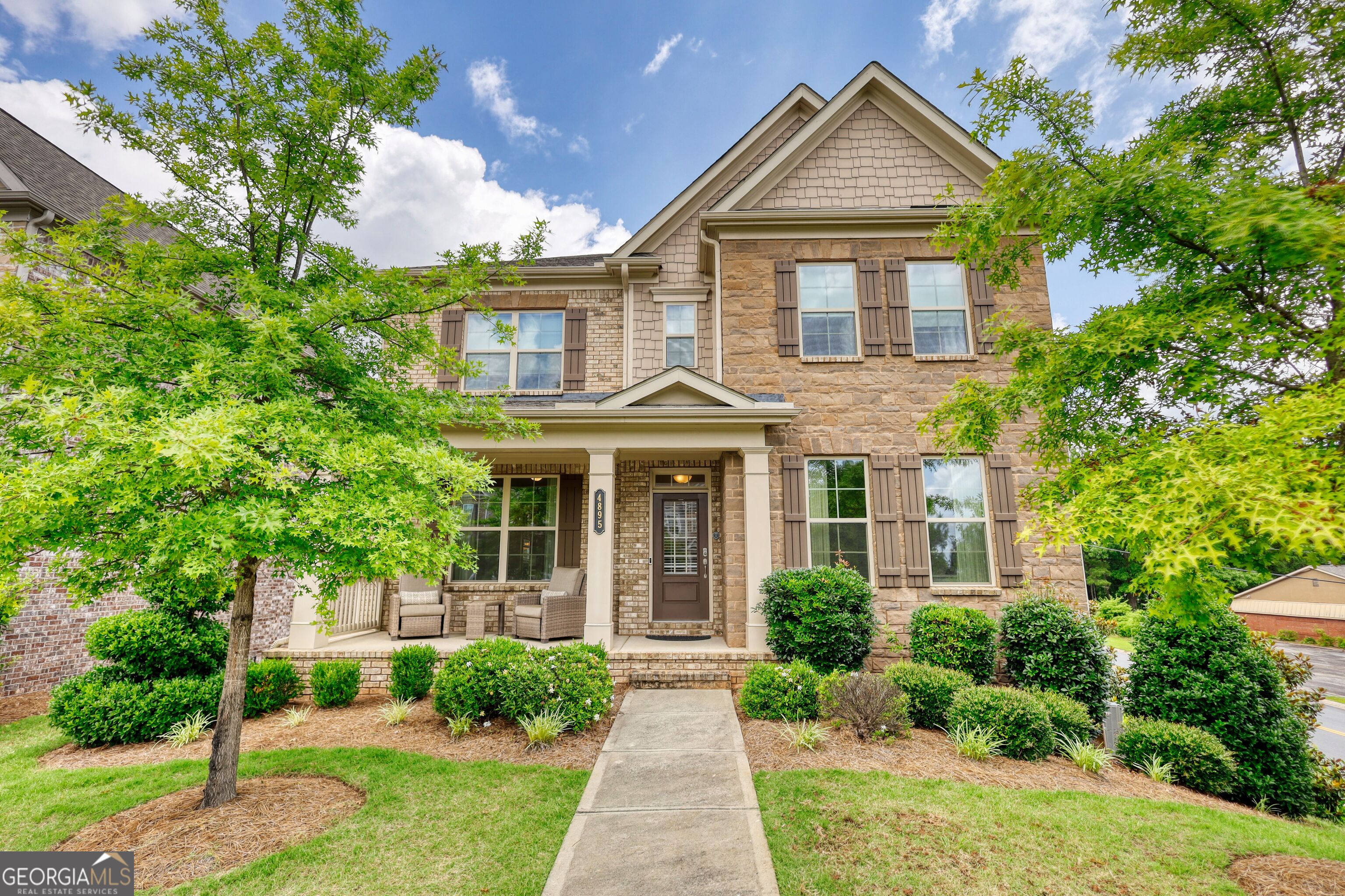 Gorgeous Move In Ready Home! This beautiful home qualifies for a credit of up to 1% of the loan amount with preferred lender! Welcome to the Home That Has It All - In the #1 School District in the Nation! Prepare to fall in love the moment you arrive at this extraordinary corner-lot masterpiece nestled in the prestigious Buford City School District - now ranked the best in the country. Every inch of this home is a statement of elegance, comfort, and intentional luxury, with over $40,000 in high-end upgrades since 2022 - and not a single detail overlooked. From the moment you step inside, you're met with a sense of refined grandeur: Expansive open-concept living, rich engineered hardwoods throughout (yes - no carpet anywhere), and light pouring in from every angle. Host unforgettable holiday gatherings in the formal dining room, where elegance meets function. At the heart of the home? A show-stopping chef's kitchen worthy of a magazine cover - complete with gleaming stainless-steel appliances, crisp white cabinetry, a massive granite island, and a butler's pantry that elevates everyday living into a luxurious experience. The breakfast room seamlessly connects the kitchen to the living space, with plenty of room for a six-person table - all flowing into a designer-inspired family room featuring custom white built-ins topped with granite, and a beautiful fireplace, creating an atmosphere that's both welcoming and upscale. Step outside to your covered deck retreat, where the outdoor fireplace invites cozy mornings and wine-filled evenings overlooking peaceful, tree-lined views - a rare and tranquil extension of your living space. Downstairs also includes a private fifth bedroom or executive office, adjacent to a full bath with a custom tiled shower - perfect for multigenerational living, guests, or working from home in total comfort. Upstairs, discover your dream owner's suite - a serene sanctuary with spa-like vibes: * California-style ensuite with dual granite vanities * Oversized garden tub and glass-enclosed shower * A custom walk-in closet designed to make mornings effortless Three additional spacious bedrooms await, with a thoughtful Jack & Jill bath between two, and a private en-suite for the third - the ideal setup for teens, in-laws, or guests. The second floor includes a generously sized laundry room with abundant storage, making laundry day feel efficient, organized, and even enjoyable. And there's more... The daylight basement, already plumbed for a full bathroom, is your blank canvas: home theater, gym, game room, wine cellar - the possibilities are endless. The three-car garage features brand new epoxy floors, providing the polished, showroom-style finish that's the cherry on top. Why wait? Homes of this caliber in Buford's top school district don't stay on the market. Schedule your private showing today and experience what it feels like to truly come home - to luxury, location, and lifestyle in perfect harmony.