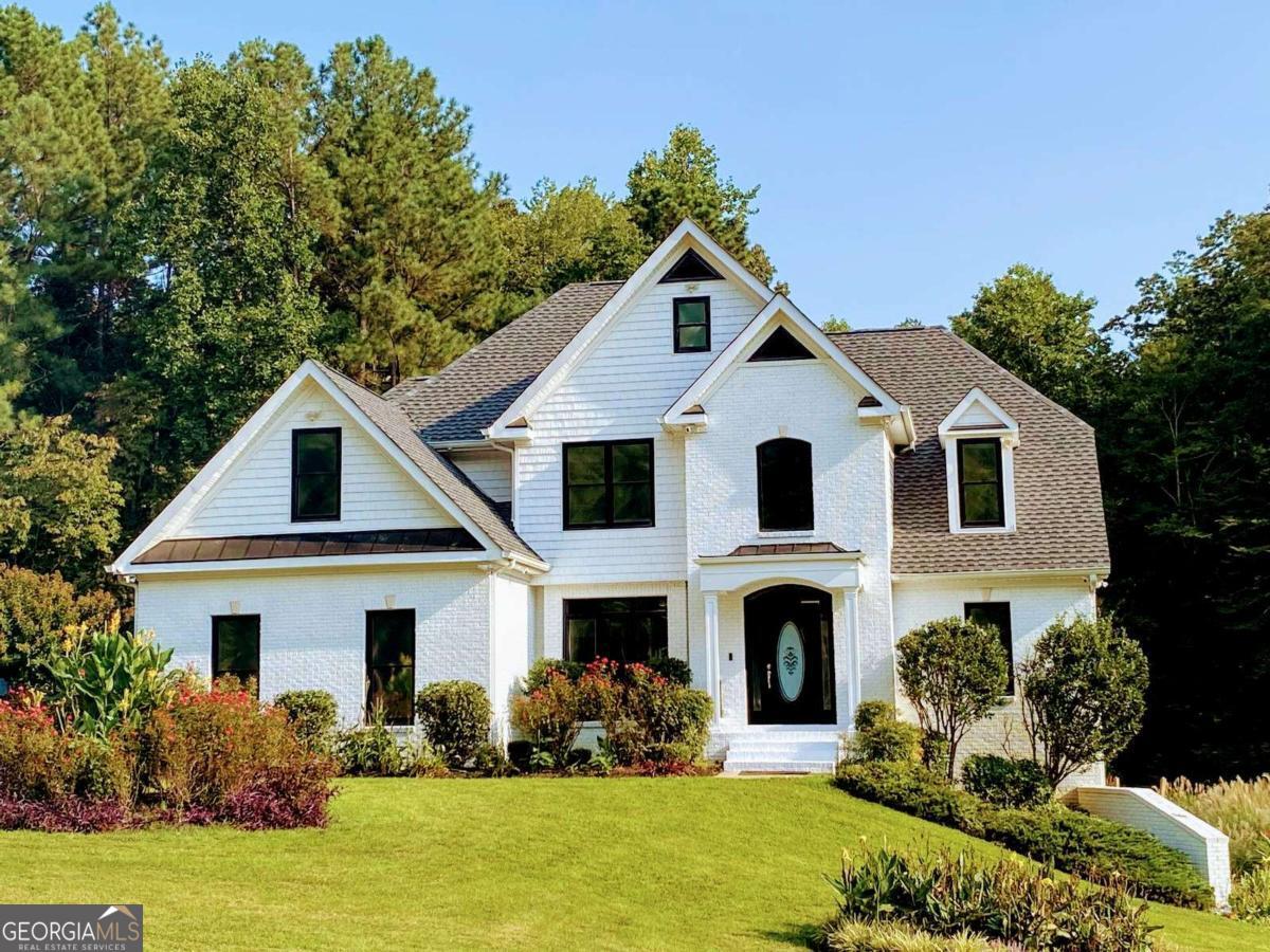 Gorgeous custom home with 3 lots for approx. 3.7 acres in sought after Paulding county. The upper lot is buildable so you could start a family compound or build a second home. The private back yard slopes gently to a charming creek which attracts deer and wildlife. The yard boast a park like Setting, garden w irrigation and orchard. The front of home is level and to the side is a Putting green for the golf enthusiast ! There is also a fenced in dog run for your fur babies! This home is newly remodeled and is ready to move in. This custom estate has a spacious and open floor Plan. The great room has a view to kitchen and breakfast room and deck. Custom granite counters and stainless steel appliances in chefs gourmet kitchen. Large deck for grilling and family gatherings. Family Rm has warm fireplace for Winter hot toddies. The master on main is spacious and has a brilliant walk in cedar closet. The master bath has a Jetted tub and walk in shower and custom steam shower. There is an additional bedroom and full bath on main level for either mother in law or private office or work out room, The second floor has 3 spacious bedrooms and 1 full baths for family and friends. A total of 6 bedrooms if needed or 5 bedrooms and office. The basement is designers dream and fully finished. It could be a separate living quarters For an extended family or mother in law apartment. It has 2 sliding barn doors and custom siding. It has a large bedroom , family room, sun room or work out room, and kitchenette. There is an office or dining area off kitchenette with custom barn wood siding. The bathroom is Awesome with double shower heads and double vanities. The family room opens to private covered patio and beautiful back yard. A Compact work shop with double door (boat door) And shelving is also in basement. The upstairs garage has epoxy flooring and more shelves for storage. There is ample parking available. During inclement weather you will not lose power due to 20 kw Generac generator. There are too many upgrades to list. This park like setting has approx. 60 x 20 ft fenced pen for you fur babies or for Chickens!! There is an adorable chicken home with automatic feeders attached to fenced pen and netting for covering the pen. The orchard boast: apple trees, fig trees, blueberry bushes , etc... You can build memories to cherish on this estate! This is a deer hunters, bird watchers, and nature lovers paradise ! Fun for 4 wheelers too!