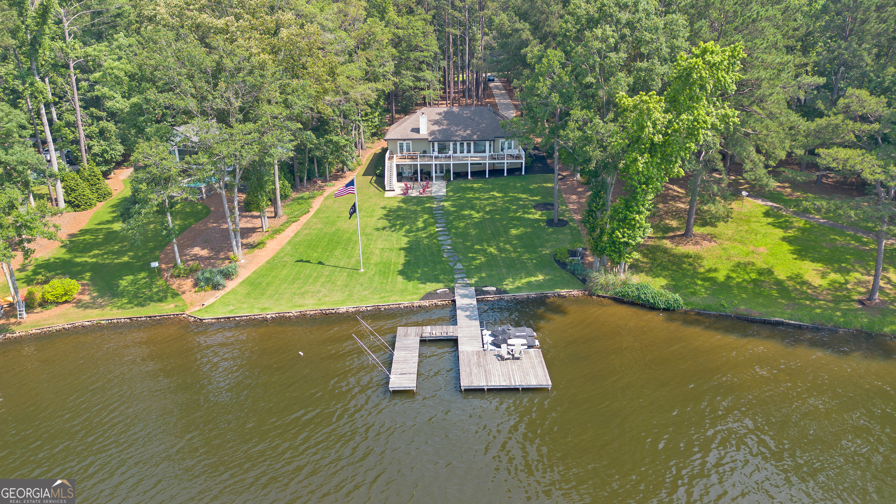 Lake Oconee Retreat featuring timeless 4-sided brick construction, 6 spacious bedrooms, and 4.5 baths-offered fully furnished for immediate enjoyment! This beautifully updated lakefront home offers the perfect blend of comfort, space, and convenience. The main level features a spacious primary suite with a private en-suite bath, two additional bedrooms with a full bathroom, and an open-concept living area filled with natural light and sweeping lake views. A gourmet kitchen with a gas cooktop and double oven makes entertaining a breeze. The finished basement is ideal for multigenerational living or guest accommodations, offering walkout access to the lake, a fully equipped wet bar with a full-size refrigerator, dishwasher, and ice maker, plus three generously sized bedrooms, two full bathrooms, and a half bath. Whether you're lounging by the water, launching your boat, or enjoying a sunset paddle, this property makes it easy to embrace the lakefront lifestyle. It's a fantastic opportunity for a second home, short-term vacation rental, or full-time residence. Additional features include laundry on both the main and lower levels, a community boat ramp, and full furnishings included. Located approximately one mile from Harmony Crossing with easy access to retail, restaurants, and the future Publix Shopping Center.