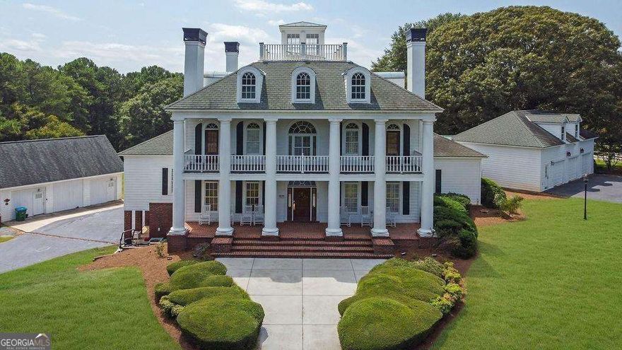 Welcome to Paradise on Ross Road - an extraordinary private estate where timeless elegance meets relaxed country living. Set on nearly 7 pristine acres of fenced pastureland, this one-of-a-kind property offers peace, privacy, and an abundance of luxurious space. From the moment you arrive, the stately presence of this traditional-style home captivates, framed by grand pillar columns and a gated, circular driveway set far back from the road. Step inside the breathtaking two-story foyer, where a sparkling chandelier glows above gleaming Italian marble tile - a striking first impression that sets the tone for what's to come. This home is expansive, yet warmly inviting - boasting 7 bedrooms, 5 full baths, and 2 half baths, with exquisitely detailed finishes in every room. Seven fireplaces throughout the home create cozy gathering spaces, each with its own charm. Real hardwood floors, elegant trim work, crown molding, and plantation shutters fill every corner with timeless beauty. The formal living room or study is adorned with built-in bookshelves - a quiet place to work or reflect. The formal dining room easily seats 12, perfect for holiday feasts and special occasions. Flow into the heart of the home: a soaring great room with tall ceilings, a dramatic fireplace, and more custom built-ins - all open to a sunny breakfast room and chef's kitchen. This gourmet kitchen is a dream: cherry custom cabinetry, solid granite countertops, two 9-foot granite bars, and an oversized granite island make it perfect for preparing meals and entertaining. Professional-grade stainless appliances, a gas cooktop, double sinks, and an upgraded hardware package bring form and function together beautifully. Just off the kitchen, a large bonus room offers flexibility, and an expansive sunroom with slate/flagstone flooring and floor-to-ceiling windows creates a serene space to relax. Two additional fireplaces add warmth and character. The main-level owner's suite is a sanctuary, with a sitting area, hardwood floors, custom fireplace, massive walk-in closet, and spa-inspired bath featuring an 8-foot Jacuzzi tub, oversized tiled shower, and exquisite marble tile. A second upper-level master suite is equally impressive, with vaulted trey ceilings, plantation shutters, a sitting area with beautiful views, and a luxurious bath finished in travertine with double vanities and its own Jacuzzi tub. Upstairs, each secondary bedroom includes its own bath and walk-in closet - ideal for guests or a large family. The finished terrace level is a true entertainer's retreat, complete with a second kitchen, bar seating, built-in booths and tables, a game room, and large family room. Whether you're hosting friends or unwinding with loved ones, there's space for every moment. But the magic doesn't stop there - a separate Carriage House includes its own kitchen, bathroom, bedroom, and living space, plus a professional music studio ready for creativity to flow. Step outside to your personal paradise: a cobblestone patio with fire pit, vibrant gardens, and an elegant custom swimming pool surrounded by tranquil views of lush pasture and mature fruit trees. It truly feels like a luxury resort, right at home. With 6.86 acres of fully fenced land, there's plenty of room to bring your horses and live the lifestyle you've dreamed of - all with no HOA and a premier location close to everything. This isn't just a home - it's a masterpiece. It's comfort, luxury, and freedom, all in one. Come experience the peace and beauty of Ross Road. Your private retreat awaits.