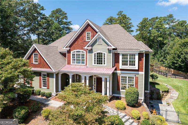 Luxury, Privacy & Thoughtful Upgrades on 2 Acres - Discover a rare opportunity to own a custom estate home in one of Canton's most sought-after communities - an intimate enclave of just 11 homes. This masterpiece offers 5 bedrooms, 4.5 bathrooms, a finished walkout terrace level, a huge workshop/potential ADU, and an incredible 2-acre private lot with no detail overlooked. From the moment you arrive, the home's stately curb appeal is undeniable-lush landscaping, a mechanical gated entry, and an inviting covered front porch set the stage. Step inside to a dramatic two-story foyer and living room with soaring ceilings, abundant natural light, and views of the backyard oasis. The gourmet kitchen is a chef's dream-featuring granite and quartz countertops, high-end appliances, a large island, custom cabinetry, and seamless flow into the dining and keeping areas. The home's main level is designed for both elegant entertaining and comfortable daily living, with upgraded lighting, fresh interior paint, and new fixtures and faucets throughout. The owner's suite is a private retreat, complete with a spa-inspired bathroom and custom closet system. Upstairs, you'll find generously sized secondary bedrooms and bathrooms, while the fully finished terrace level offers a home theater, wet bar, office, and abundant space for recreation or guests. This property is brimming with premium upgrades, including: Thermal-tinted windows for energy efficiency, Updated electrical switches & outlets, New carpet throughout the home, Epoxy-coated floors in the 3-car garage with new garage door openers, Wood-burning fireplace conversion for cozy ambiance, Custom railing added to front steps, Motorized gate and fencing for security and privacy, Custom closet systems. The detached 3040 climate-controlled workshop is a rare find-spray-foam insulated with RV-ready power and tall ceilings-perfect for hobbies, car collection, or business use. The potential accessory dwelling unit (ADU) now boasts its own new septic system and is ready for build-out, with construction plans included. Outside, enjoy your own private retreat with professionally landscaped grounds, fruit trees, berry bushes, a garden area, irrigation, and plenty of room for a future pool. Located in the top-rated Sequoyah High School district and just minutes to shopping, dining, and I-575, this home delivers luxury, privacy, and unmatched functionality. Schedule your private showing today-homes of this caliber rarely hit the market in Canton.