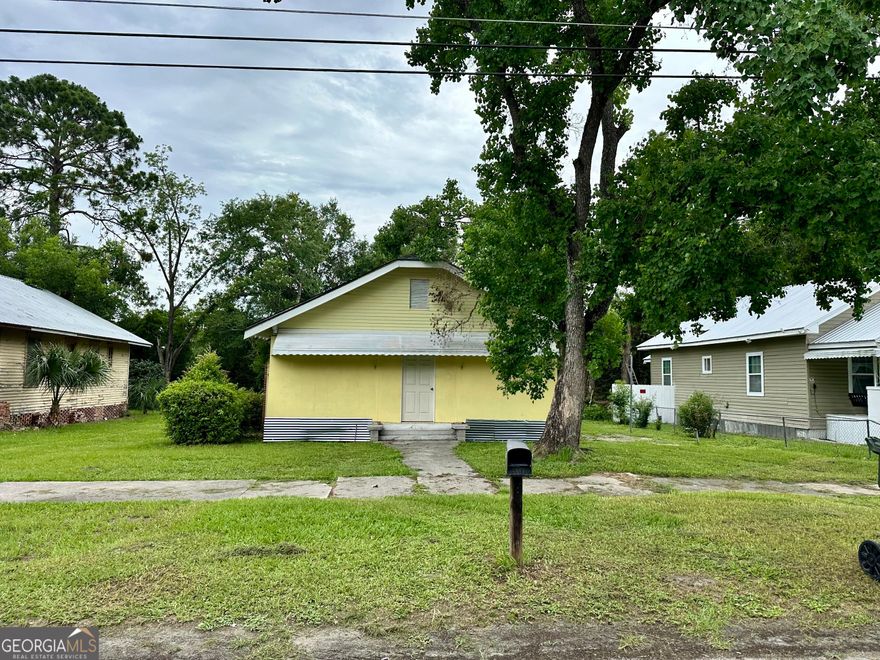 310 Butler Street | Fixer-Upper Opportunity | Investment Potential    Calling all investors and renovators! This 3-bedroom, 1-bath home in the heart of Waycross offers solid potential and classic character. Features include spacious living areas with tall ceilings, original wood floors, large windows, and vintage fireplaces. The layout provides great bones for a remodel or rental property.    The exterior features a metal awning, low-maintenance siding and yard space.Some demo work has been started - bring your vision and complete the transformation.    This property is ideal for your next flip or income-producing project.    Great value for savvy investors - don't miss this opportunity!