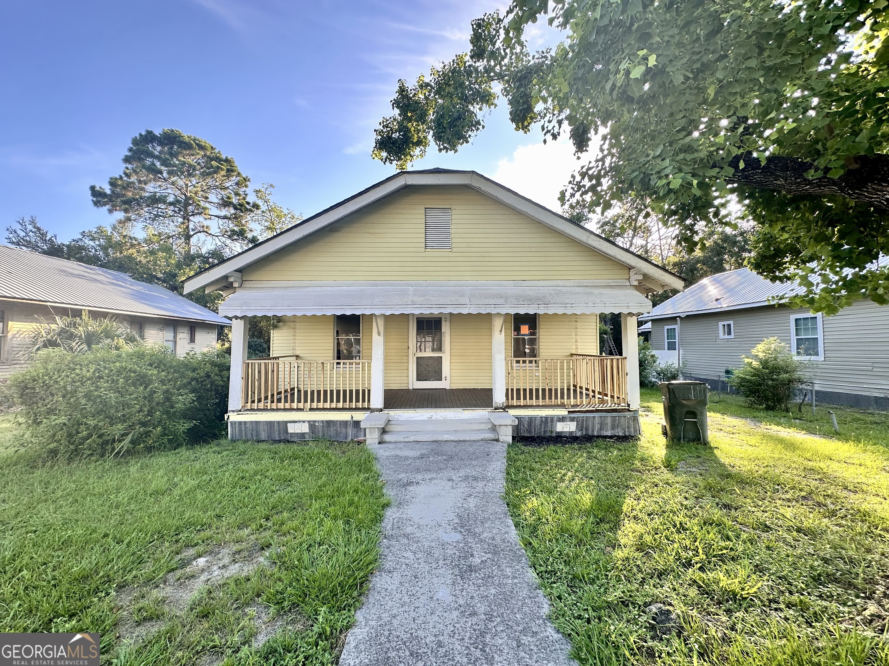 Charming Bungalow in the Heart of Waycross - 310 Butler Street This classic 3-bedroom, 1-bath bungalow offers timeless charm in a prime in-town location. A welcoming front porch with a swing sets the tone for relaxed Southern living. Inside, you'll find tall ceilings, spacious living areas, and original hardwood floors that add warmth and character throughout. Large windows fill the home with natural light, while vintage fireplaces provide a cozy, historic touch. A wonderful opportunity to own a piece of Waycross charm just minutes from downtown amenities.