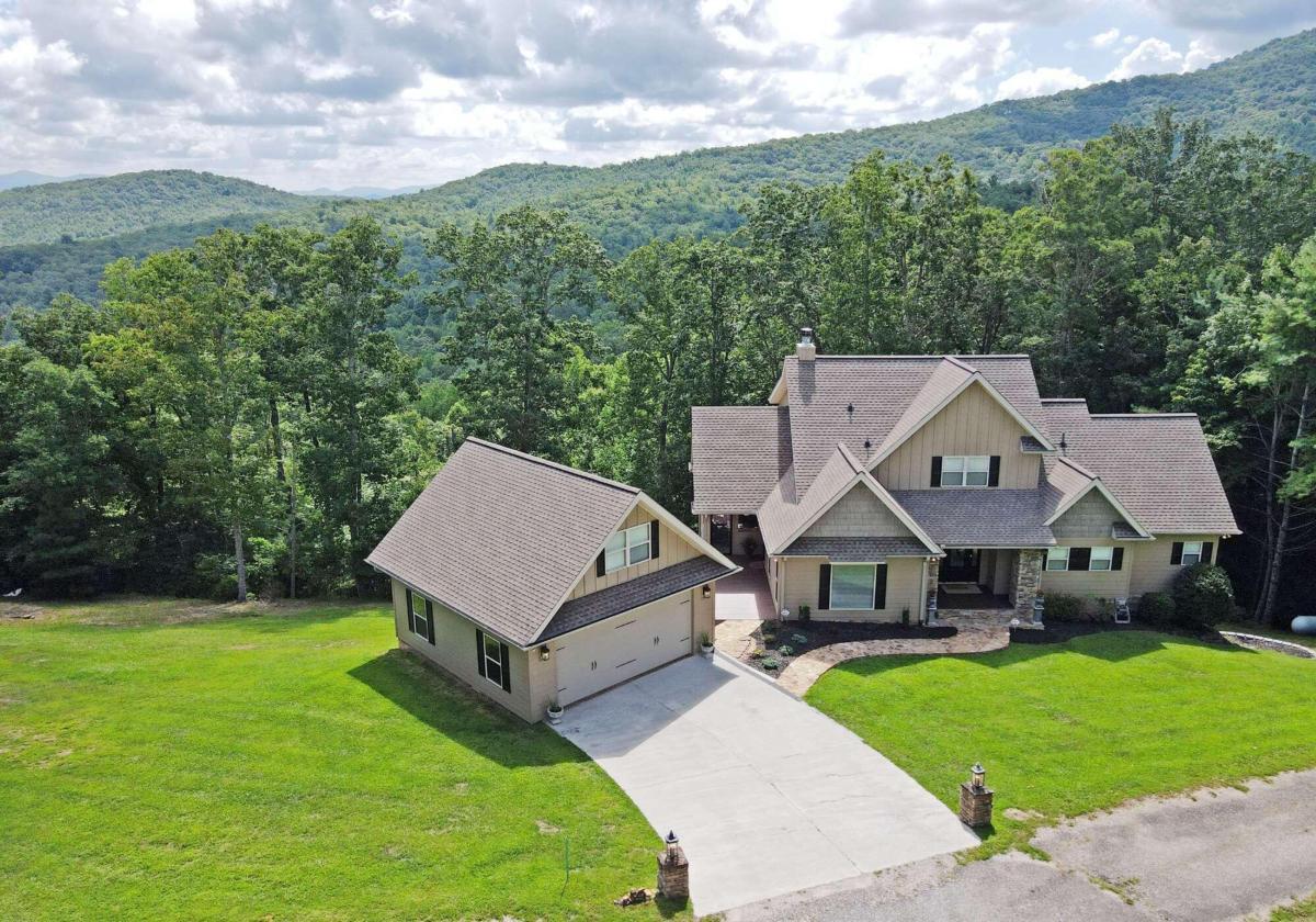 Be prepared to be WOWED! AMAZING YEAR ROUND LONG RANGE MOUNTAIN VIEWS! AMAZING WELL MAINTAINED 4BR/4BA Craftsman Style Mountain Home on 4.32 Acres only steps away from the USFS! This home features open soaring cathedral ceilings. Great Room has a Floor to ceiling stone fireplace all open into the well appointed kitchen area with granite and SS appliances. Screened porch off of the kitchen with a Massive stone wood burning fireplace. Lots of windows capturing the GORGEOUS VIEWS! Master and mudroom/laundry on the main level. Built in office in the Loft area. Terrace level boasts a HUGE family room, wet bar area, bedroom and bathroom, screened porch and a large deck. All NEW Composite board decking throughout home. Zoned HVAC, Generator, Dog Kennels and SO MUCH MORE! Call me today!