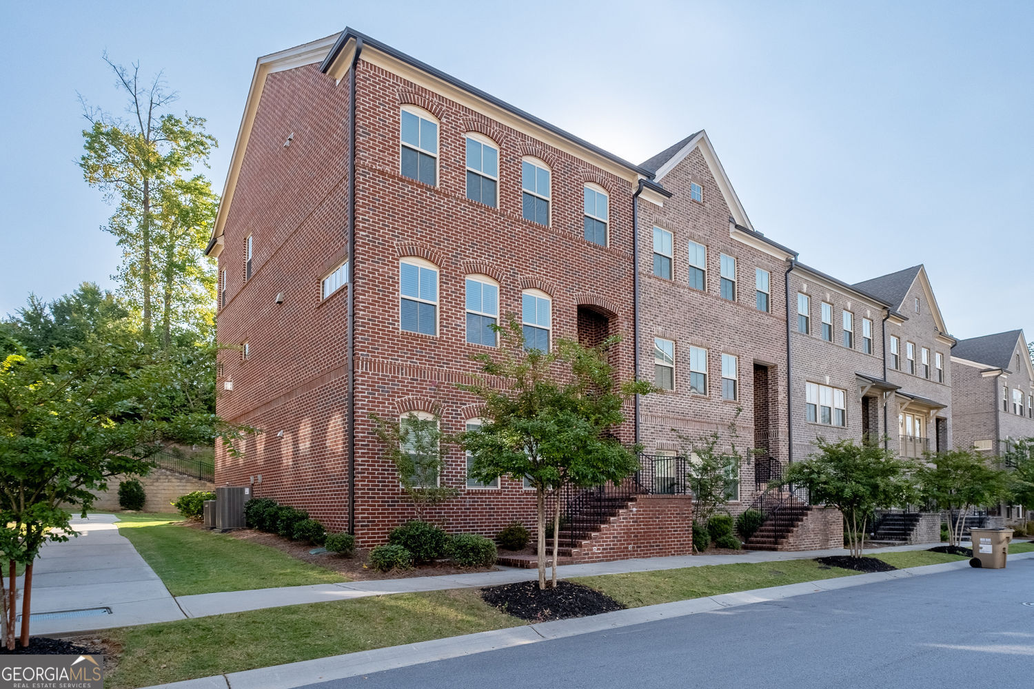 Incredibly Rare End-Unit Townhome With Spacious Double Primary Suites & No Neighbors Behind - In Suwanee's Most Coveted Community With Direct Access To Suwanee Town Center & Award-Winning North Gwinnett Schools! This Executive 3 Bed, 3.5 Bath Residence Delivers The Perfect Blend Of Privacy, Walkable Convenience, And Luxury Living. The Bright, Open-Concept Main Level Features A Gourmet Kitchen With Oversized Island Overlooking The Dining And Living Areas Complete With An Office Nook, Flowing Seamlessly To A Private Rear Deck That Extends Your Living Space Outdoors - An Entertainer's Delight! Upstairs, Discover A Rare Double Primary Suite Layout, Each With Spa-Inspired Baths And Generous Walk-In Closets, Alongside Convenient Second-Floor Laundry. The Terrace Level Showcases A Versatile Space That Can Serve As A Guest Suite, Private Office, Or Media Room, Complete With A Full Bath And Access To The Oversized Two-Car Garage. Every Room Is Thoughtfully Appointed, Spacious, And Filled With Natural Light. With HOA-Covered Exterior Maintenance And Lawn Care, You'll Have More Time To Enjoy Low Maintenance Living In Your Private Enclave With Walkable Lifestyle Just Steps To Shops, Dining, Stillfire Brewing, Delay Nature Park, Year-Round Events. Named By Money Magazine As One Of America's Top 50 Best Places To Live in the US, Come And See Why For Yourself!