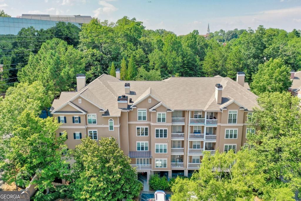 Maintenance-free lifestyle meets unparalleled convenience in the heart of Dunwoody! This gated, lushly landscaped community offers resort-style amenities including a sparkling saltwater pool and a well-equipped fitness center, inviting you to relax into your best life. The fireside living room adjoins the dining area, creating an open, inviting space for relaxation or entertaining. Beyond, a private balcony awaits, perfect for your morning coffee or evening unwind. The chef's kitchen includes stainless steel appliances, a convenient pantry, and abundant counter space, alongside a breakfast room. Both bedrooms are generously sized and filled with natural light, featuring spacious closets for all your storage needs. Enjoy ultimate accessibility with proximity to UPS and Mercedes-Benz, Dunwoody Village, Perimeter Center, the iconic King and Queen Buildings at Concourse, Dunwoody Nature Center, Spruill Center for the Arts, and effortless access to I-285 and GA400. You'll have one covered parking space and ample visitor parking. Just say WOW!