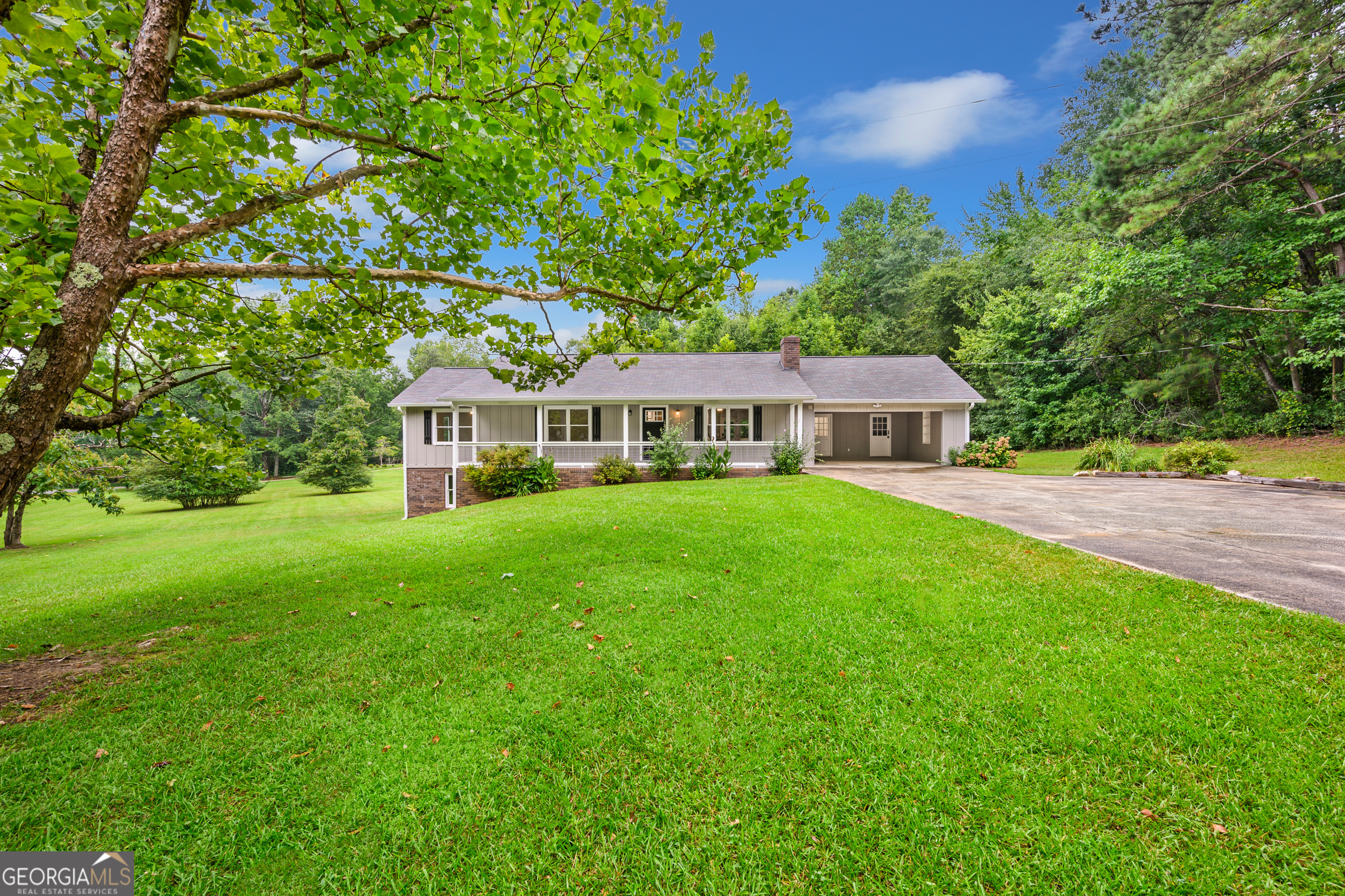 Welcome to your peaceful retreat. Where timeless brick charm meets modern comfort on a spacious 2-acre lot. This fully renovated 3-bedroom, 2-bath brick ranch is a rural gem. Blending timeless charm with modern updates, the home features thoughtful touches throughout.. from upgraded door handles and light fixtures to beautifully renovated bathrooms. The bright, open-concept living area welcomes you in, anchored by a real masonry wood-burning fireplace for cozy evenings. The stunning kitchen offers wood-stained cabinetry, granite countertops, stainless steel appliances, and two large kitchen islands equipped with cabinetry and electrical connections. Perfect for both everyday living and entertaining. A dedicated pantry includes an additional utility space ideal for storing brooms, vacuums, and small appliances. The home also boasts a convenient laundry room and a mudroom with a built-in bench with coat hooks. The full, drive-in basement provides ample storage and the potential for future expansion. The carport includes extra storage space and offers the option to be converted into a full garage, with hidden crawlspace access neatly tucked away. Outside, the expansive yard is mostly cleared with minimal trees, creating an ideal space for gardening, privacy, or playtime with kids and pets. Located in a quiet, established neighborhood with easy access to local amenities. This property offers the perfect balance of rural tranquility and modern convenience. Don't miss this opportunity to own a move-in-ready retreat with room to grow.