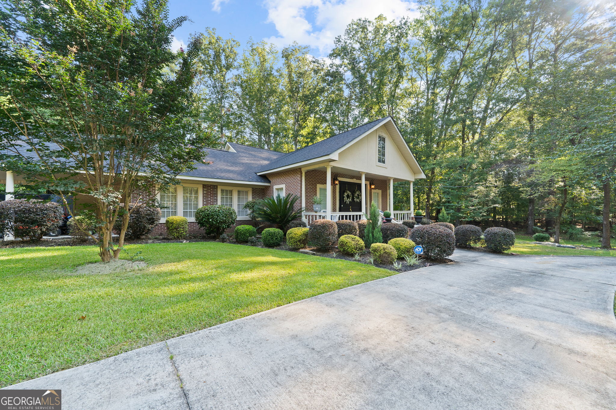 Welcome to 156 Log Cabin Road - where designer charm meets country serenity Milledgeville's most desirable community. Situated on more than 4 beautifully landscaped acres, this traditional home offers a perfect blend of comfort, style, and unique character throughout. Step inside to discover a thoughtfully updated interior with a designer feel. The primary bedroom suite, located on the main level, is exceptionally spacious and provides a peaceful retreat. Two additional bedrooms are located on the opposite side of the home-one currently serving as a home office-offering privacy and versatility. The kitchen and den flow effortlessly, creating a warm and welcoming space for daily living. A bright and inviting great-room and dining room add to the home's charm and provide ideal spots for entertaining or relaxing. A beautiful staircase leads to the upper level, where you'll find another bedroom and full bath-perfect for guests or extended family. Unique features abound, including both county water and a fully functioning well with a well house, adding value and flexibility. The established landscaping is a true highlight, with mature trees and thoughtfully curated plantings that enhance the natural beauty of the property. Don't miss this rare opportunity to own a truly special home in an unbeatable location. 156 Log Cabin Road offers space, style, and serenity-everything you've been looking for.
