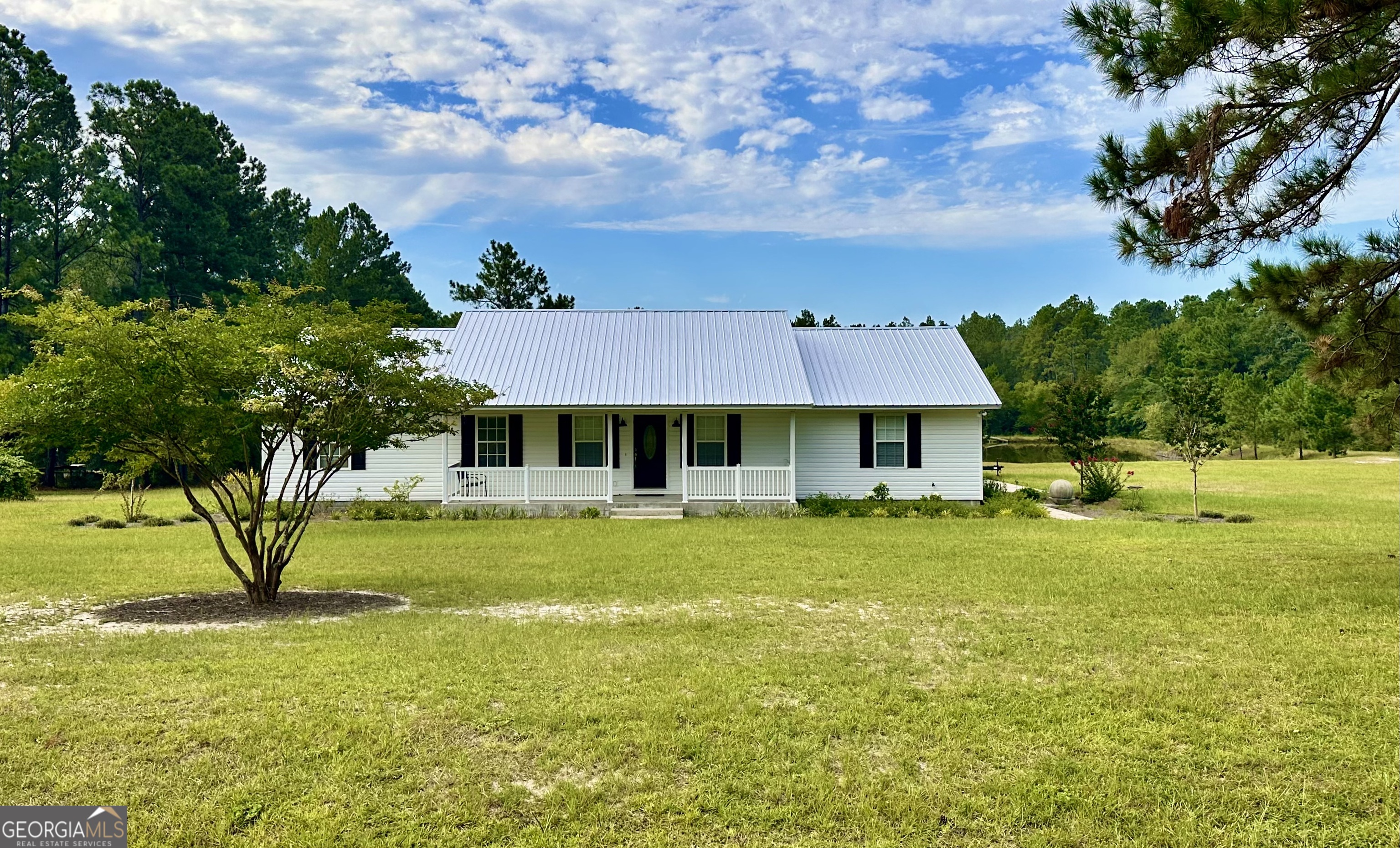 Peaceful Country Living on 5+ Acres with Private Pond Welcome to 4525 Oak View Rd - a charming 3-bedroom, 2-bath home set on over 5 serene acres with its very own pond. The property truly shines outdoors, offering plenty of cleared land with endless possibilities - start a mini farm, plant gardens, or raise animals. Cast a line in your private pond for peaceful afternoons of fishing, or enjoy watching local wildlife wander by, with deer feeders already in place to attract frequent visitors. The attached 2-car garage adds convenience and protection for your vehicles and equipment, while the inviting front porch is the perfect spot to enjoy quiet country mornings. Inside, the home features a warm and functional layout. The wraparound kitchen includes a convenient bar and open dining area, making it the ideal place to gather with family and friends. A spacious den offers a relaxing retreat, while a generous laundry room provides extra storage and workspace. Down the hall, you'll find the bedrooms and baths, designed with comfort in mind and accented with timeless crown moulding. Sellers are also offering $5,000 in concessions to go towards new carpet or upgrades, giving you the opportunity to make this home truly your own. If you're looking for space, privacy, and the chance to embrace country living at its best, this property is a must-see. 4525 Oak View Rd 3 Bedrooms | 2 Bathrooms | 5+ Acres with Pond | 2-Car Garage