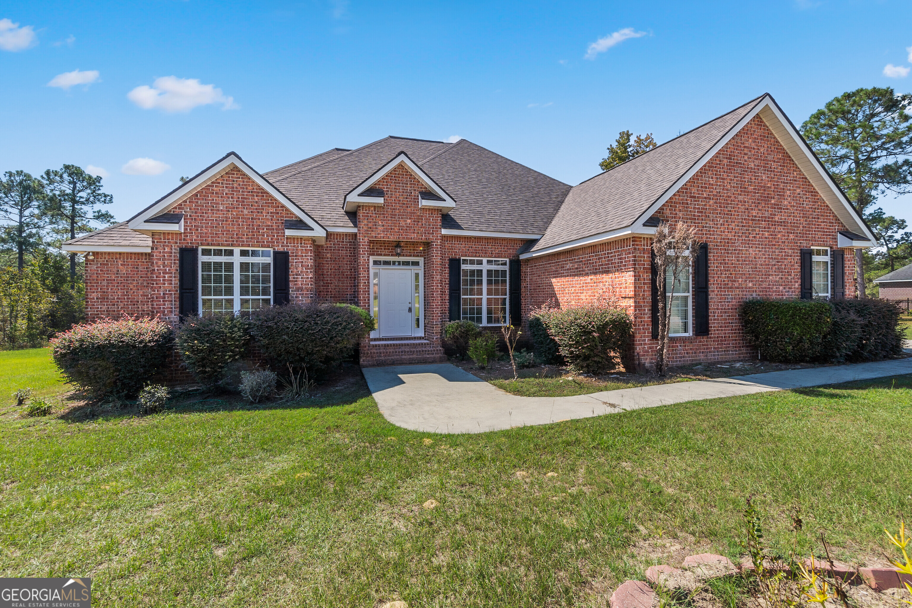 Nestled on a large, level lot in the Subsouth Bibb area, this beautiful brick home offers 4 bedrooms, 2.5 baths, and an inviting blend of space and comfort. The open and airy living room boasts a cozy fireplace, perfect for relaxing evenings, and flows into the formal dining room, ideal for gatherings and celebrations. The spacious kitchen features plenty of counter space, a breakfast area for casual meals, and overlooks the bright sunroom, providing additional living space for relaxing or entertaining. With a split floor plan, privacy is maintained as the primary bedroom is separate from the other bedrooms. The expansive owner's suite is a true retreat, featuring a walk-in closet, a luxurious jetted tub, and a separate shower, offering comfort and relaxation at the end of the day. Step outside onto the large deck, perfect for outdoor entertaining, and take in the serene views of the wooded backyard, offering a peaceful retreat. This home is a must-see for anyone looking for both space and style in a quiet neighborhood.